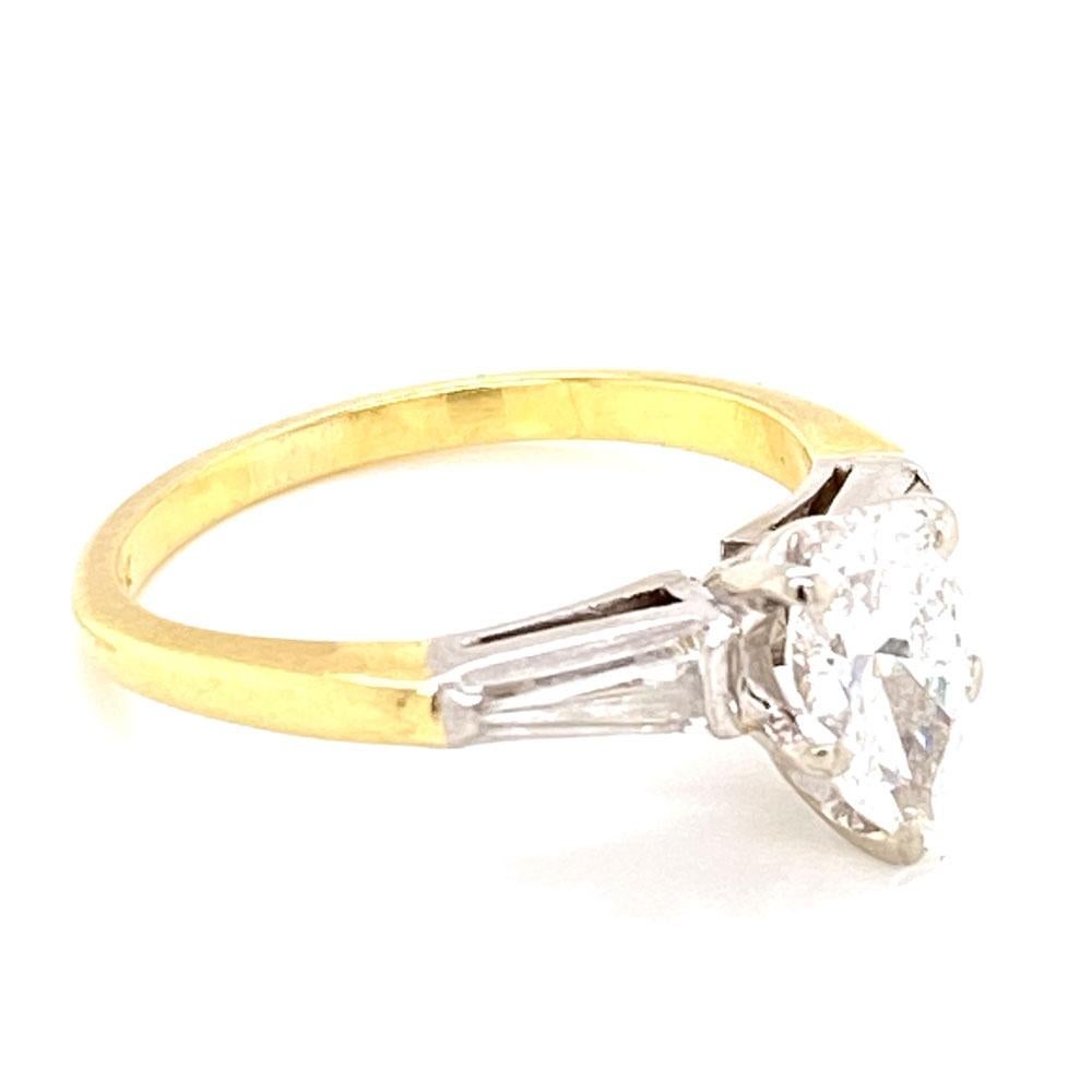 Beautiful diamond engagement ring featuring an .85 carat pear shape diamond flanked by two tapered baguettes. The center diamond has a GIA certificate grading the diamond H color and VS1 clarity. The two baguette weigh .20 carat total weight. The