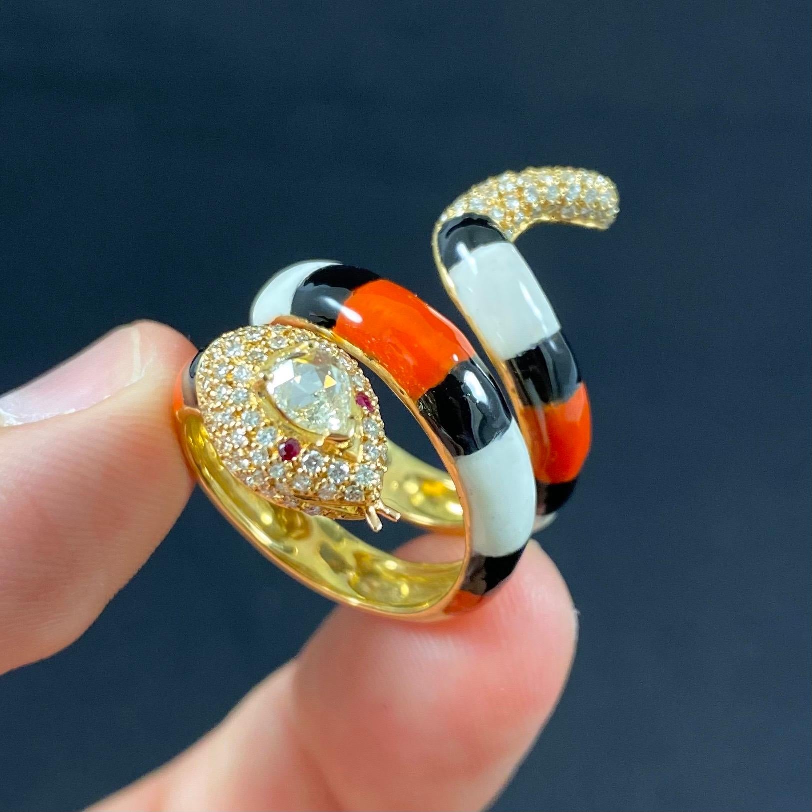 A contemporary diamond and polychrome enamel serpent snake cocktail or dress ring in 19.2 karat yellow gold, Portuguese, 2010s. This openwork ring is modelled as a snake coiling around the finger, the body embellished with orange, black and white