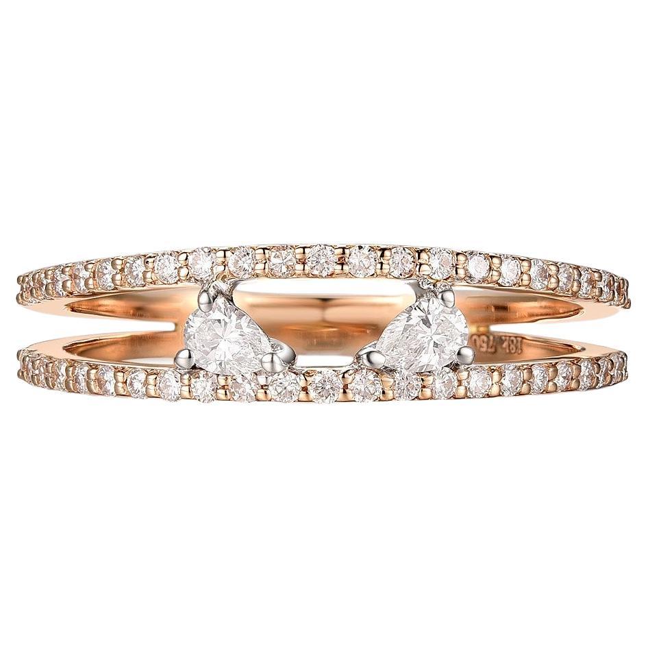The image you've uploaded shows a delicate and sophisticated ring, featuring a total of 0.37 carats of pear-shaped diamonds, set in a band made of 18 karat rose and white gold. The design is likely modern and minimalist, with the diamonds providing