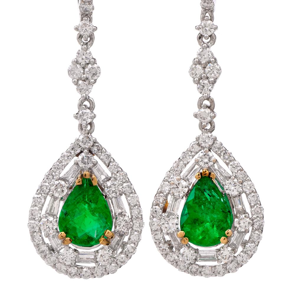 These shimmering estate emerald and diamond dangle drop earrings are crafted in 18-karat white gold. Displaying a centered pear-shaped emerald weighing approx. 1.58 carats. Prong-set with 114 round and baguette cut diamonds weighing approx. 1.97