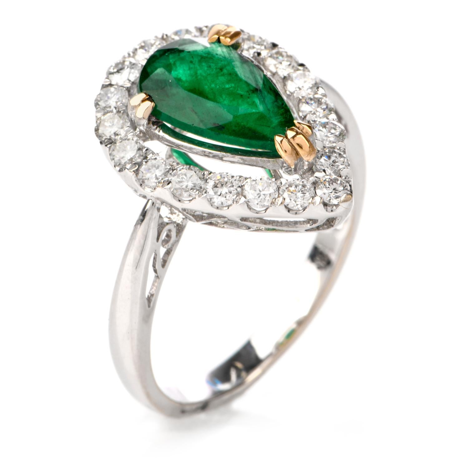 This elegant emerald and diamond ring is crafted in solid 18-karat white gold, weighing 3.9 grams and measuring 17mm x 6mm high. Composed of one prong-set pear shaped genuine emerald, weighing approximately, 1.12 carats. Surrounded by a pear shaped
