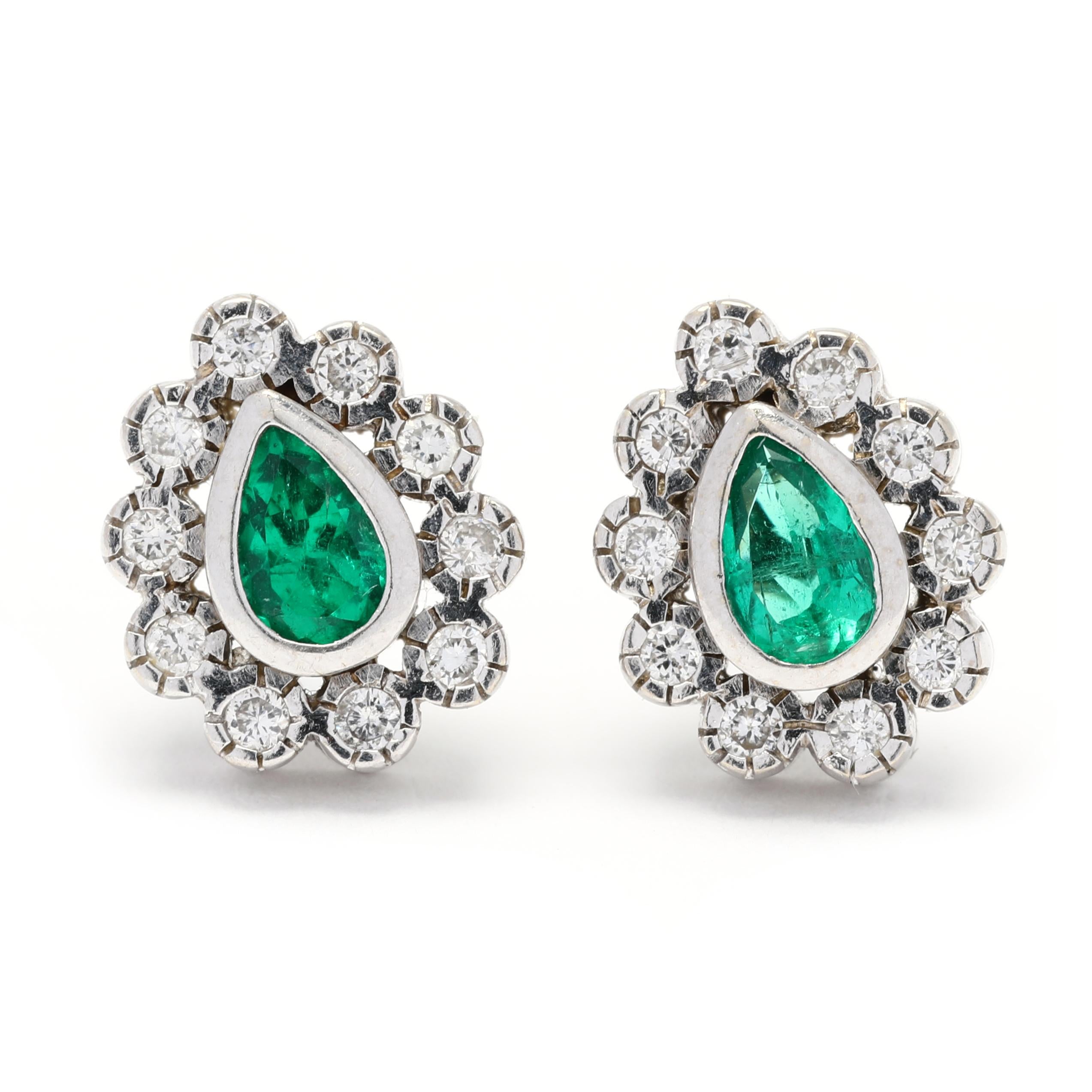 These gorgeous emerald diamond cluster earrings are a stunning piece of jewelry that will add elegance and sophistication to any outfit. Crafted in 18K white gold, the earrings feature two pear-shaped emeralds and sparkling round diamonds. The
