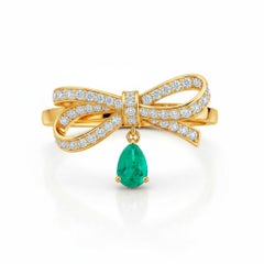 Pear emerald drop bow ring in 14k gold