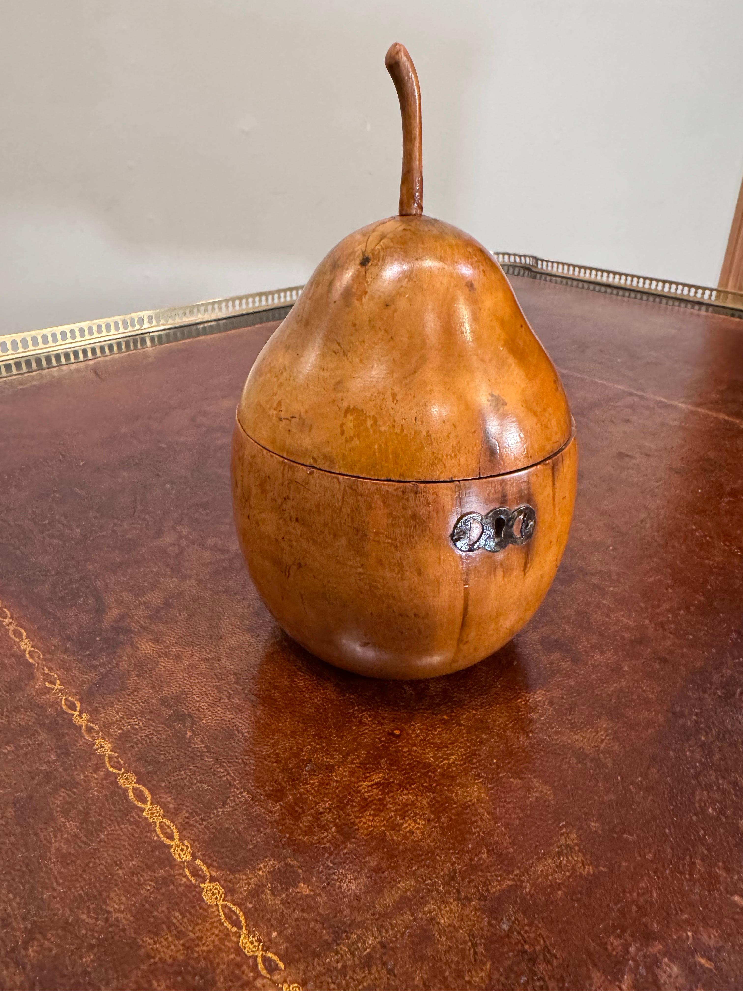 Late 18th Century George III Pear form Fruitwood Tea Caddy 

  With wooden stem, and an iron keyhole, escutcheon plate, its interior with remnants of the original silver leaf. The piece appears to retain its mostly original finish & Patina.  