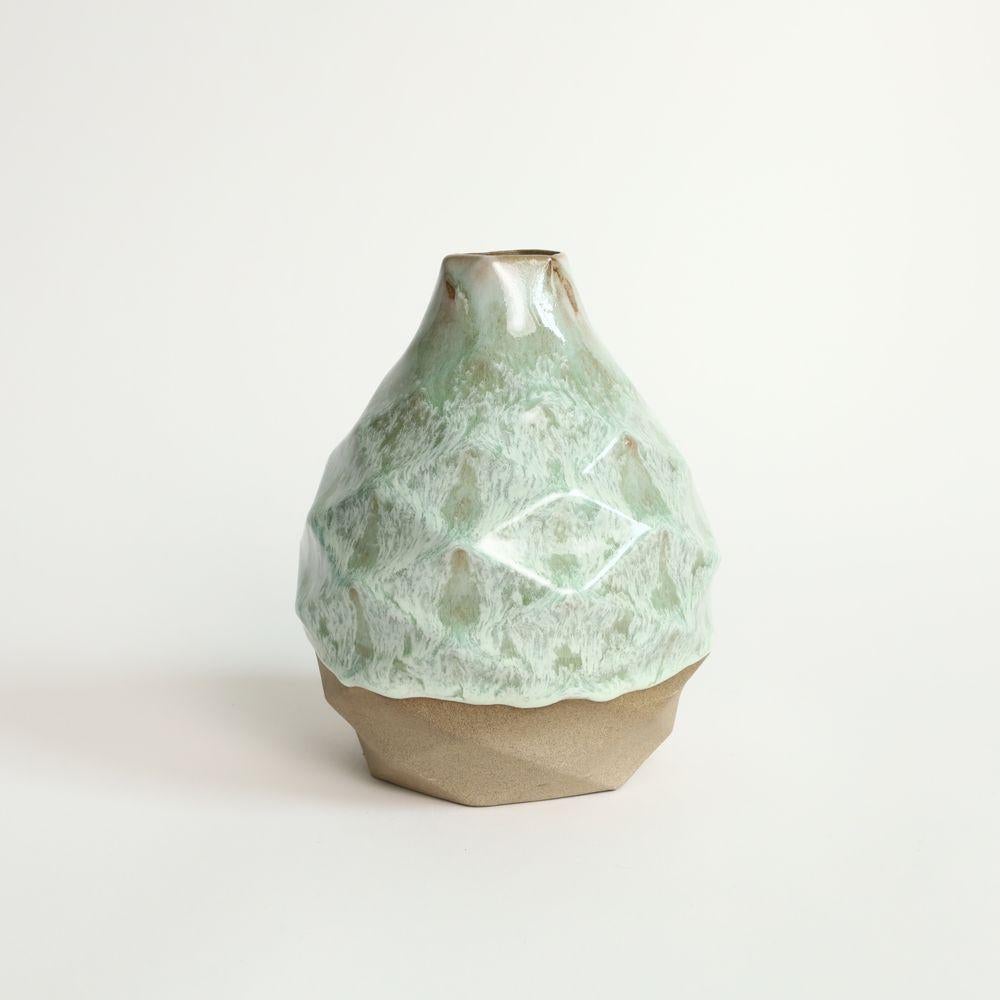 Pear in Coral Green
The Patterned Vessel Pear is a stunning decorative piece inspired by the delicious and juicy fruit for which it is named. This exquisite vase boasts a unique hexagonal profile that narrows to a slender neck, giving it an