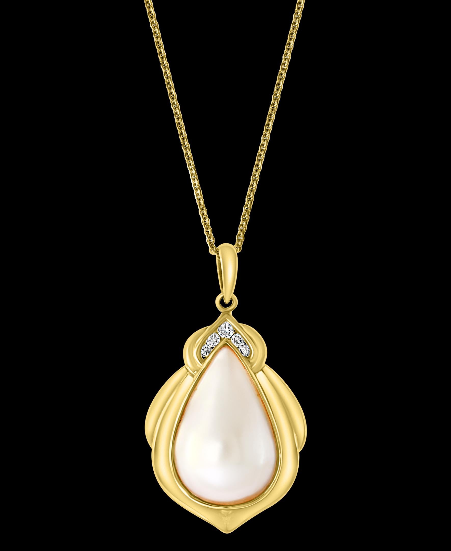 Pear Mabe Pearl And Diamond  Pendant/ Necklace 14 Karat Yellow Gold With Chain

15 mm wide and 22 mm tall pear shape mabe pearl with 5 diamonds approximately 0.25 ct 
Diamonds are eye clean quality with shine 
14 K gold Weight  7.7 Grams with