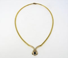 Pear Cut Emerald and Diamond Halo Omega Necklace in 18 Karat Yellow Gold