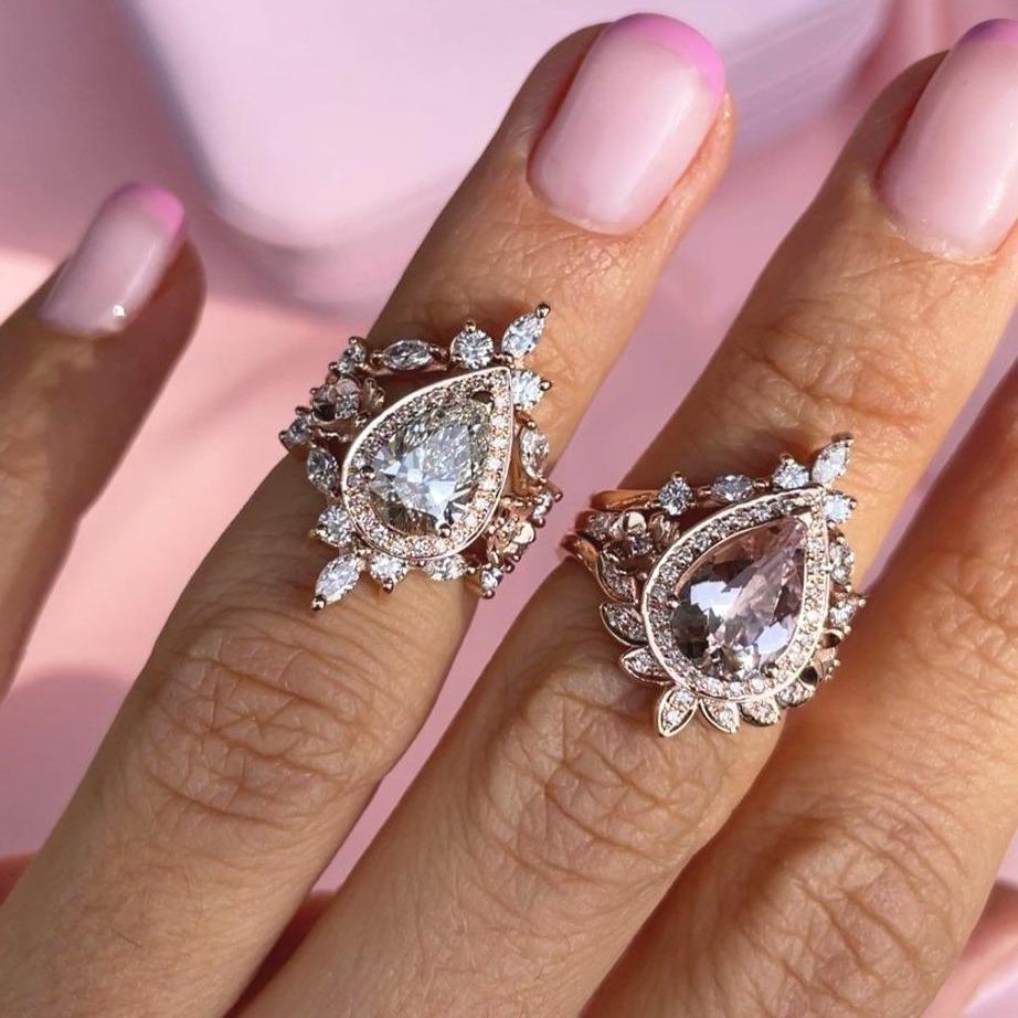 Stunning pear Moissanite and diamond halo engagement ring set. 
* The list is for the engagement three-ring set.
Handmade with care. 
An original design by Silly Shiny Diamonds. 

Details: 
* Center Stone: Pear Shape. Moissanite, 10X7mm.
* Accent