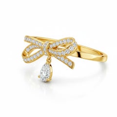 Pear moissanite drop bow ring in 14k gold