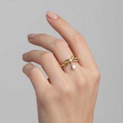 Pear moissanite drop bow ring in 14k gold