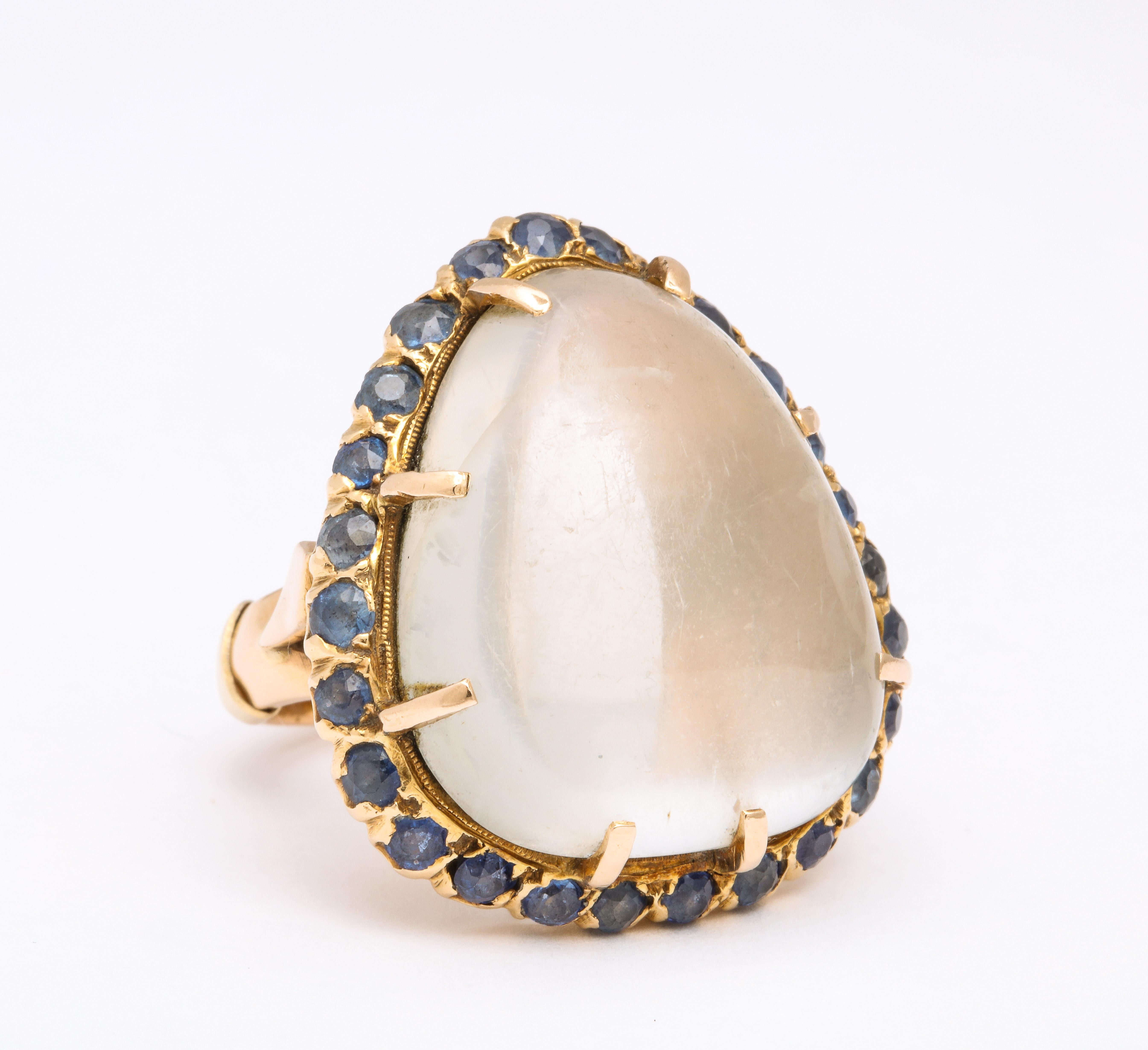 This ring showcases a beautiful 11 carat natural Pear Moonstone, surrounded by old mine cut sapphires and set in 14k Yellow Gold. It is unmarked but has been tested. 

Materials:
14k Yellow Gold, 12.0 dwt

Stones:
Unmarked but tested natural