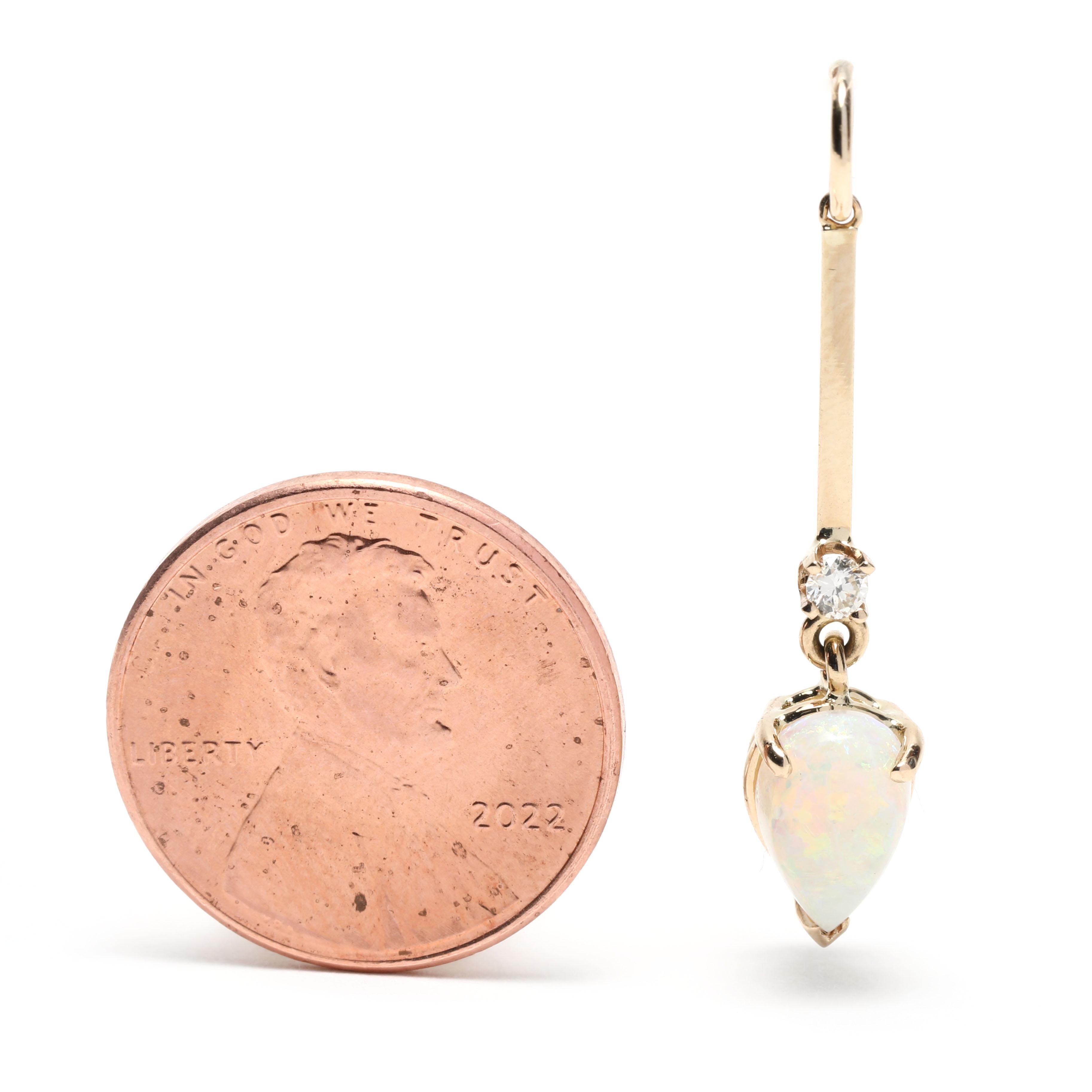 This 0.79ctw pear opal diamond dangle charm is a stunning addition to any jewelry collection. Crafted in 14K yellow gold, its 1.25