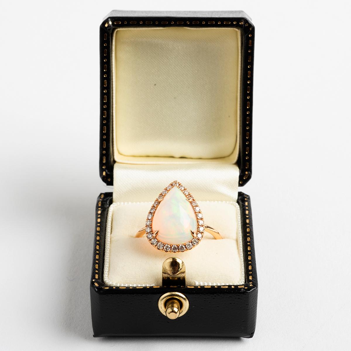 Our wonderful, large and attractive 18k rose gold dress ring features a pear shaped opal (est. 3.67carat) and diamonds (est. .29carat). Certain to centre conversation, this versatile ring adds to any attire. Hallmarked London, 2019, this ring is