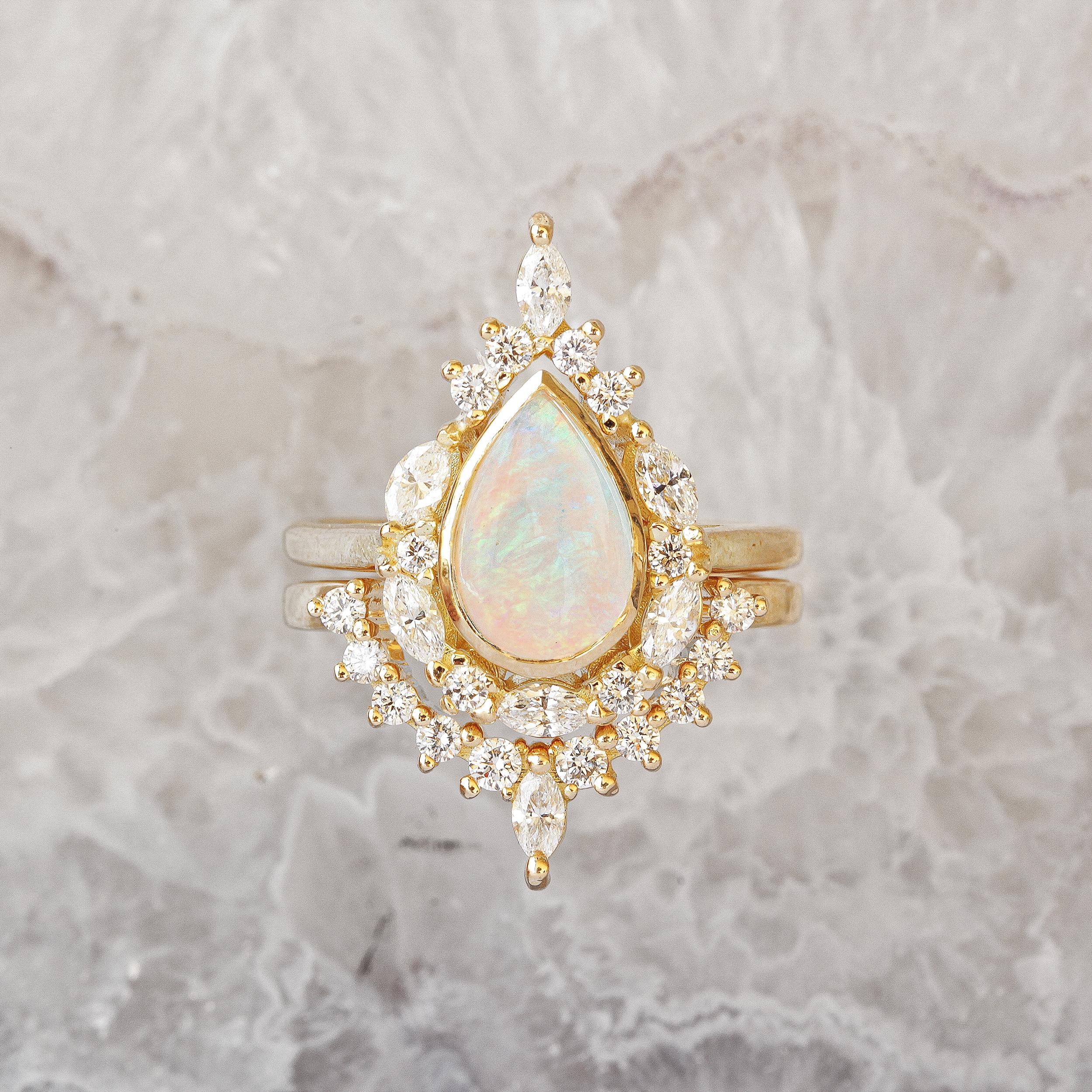 Unique pear Opal Engagement Rings Set - Eva.
The Eva ring is named after the first woman Eva who is graceful, passionate, and full of energy & laughter. 
The center stone can be personalized.
* The list is for a two ring set.
Handmade with care. 
An