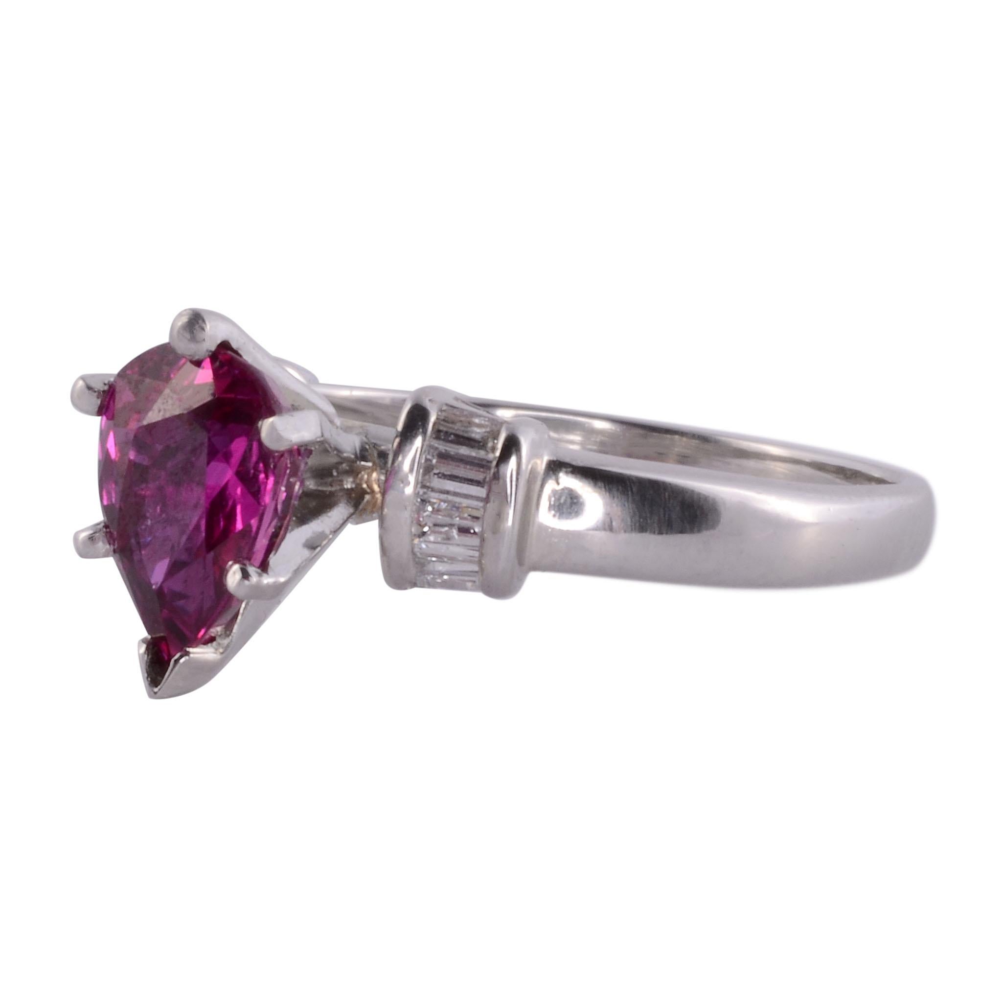 Estate pear ruby diamond platinum ring. This platinum ring features a center pear ruby at 1.61 carats accented with eight baguette cut diamonds at .16 carat total weight. The diamond have SI1 clarity and H-I color and is a size 7.75. This pear ruby