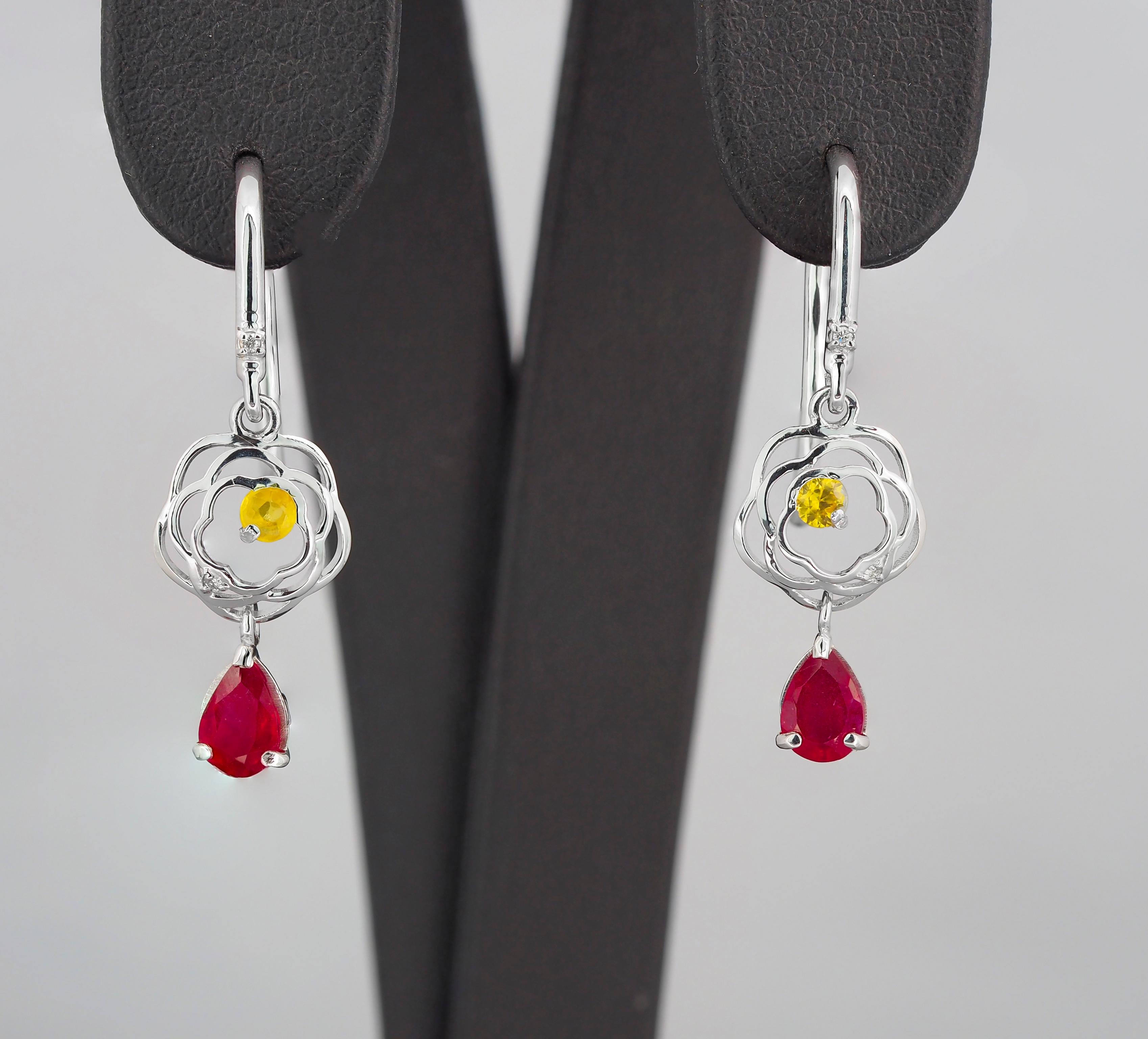 Pear ruby drop earrings in 14k gold. 
Natural ruby earrings. Real ruby earrings. July birthstone ruby earrings.

Material: 14k gold.
Weight: 2 gr.
Size Earrings: 31.5x8.9 mm.

Central stones: Natural Rubies - 2 pieces 
Cut: Pear
Weight: aprx 1.2 ct.