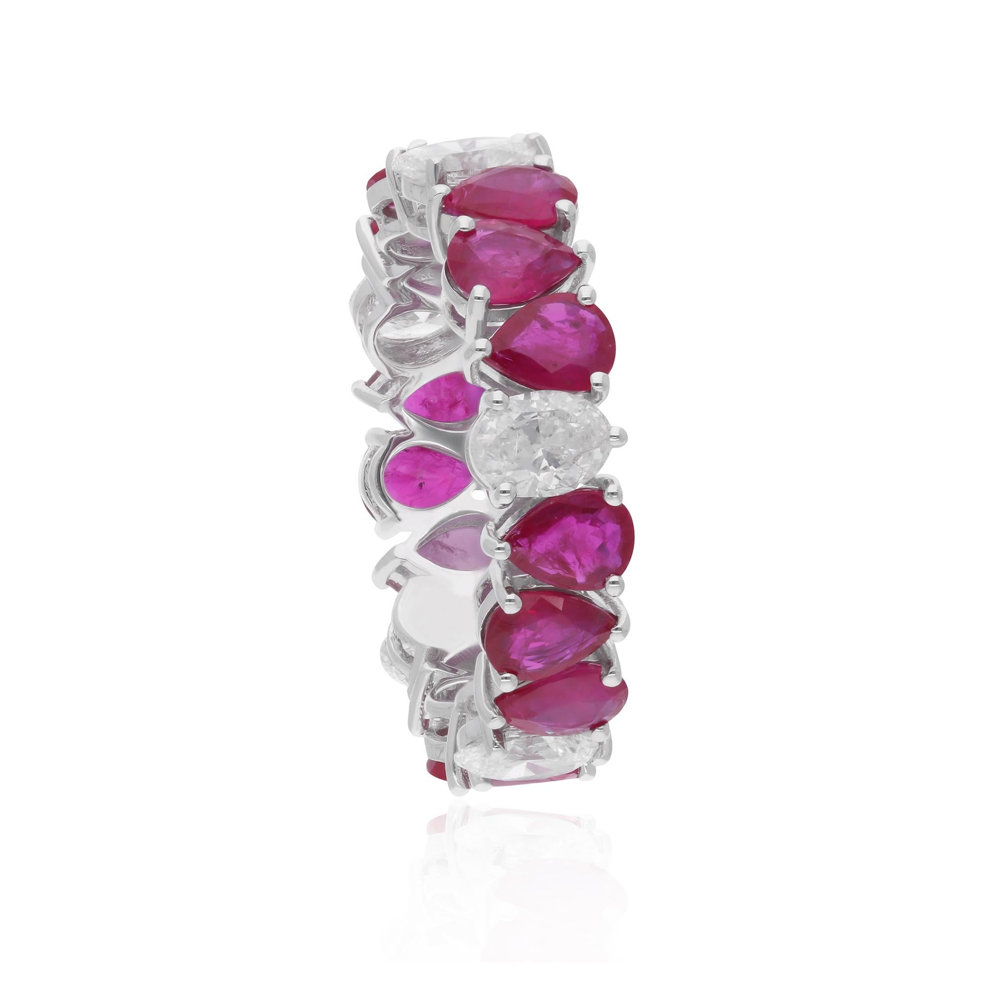 Surrounding the rubies are shimmering oval diamonds, expertly set in a pave or prong setting to maximize their brilliance and fire. With their sparkling clarity and HI color, these diamonds add a touch of glamour and luxury to the ring, creating a