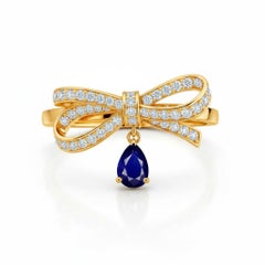 Pear sapphire drop bow ring in 14k gold