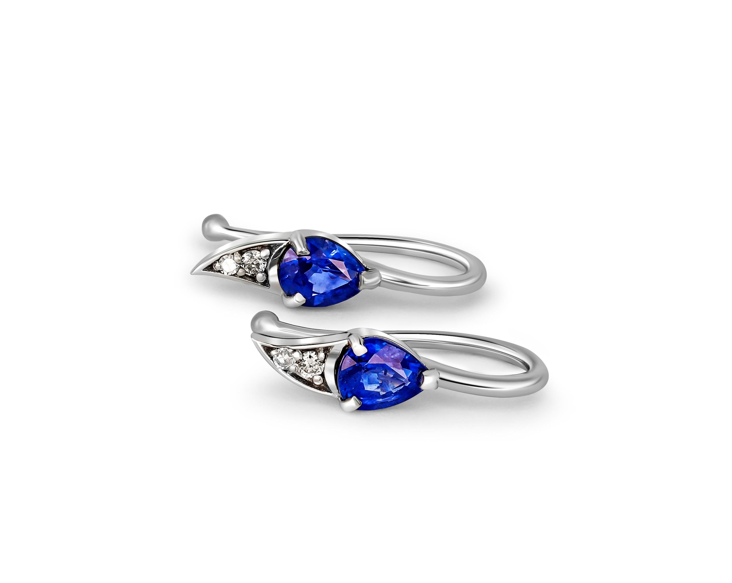 Pear sapphires 14k gold earrings. 
Blue sapphire earrings. Tiny sapphire earrings. Delicate sapphire earrings. Sapphire tear drop earrings.

Gold - 14 kt gold 
Weight: 1.5 gr
Size: 16.5x4.5 mm .

Central stones: 
Sapphires, 2 pieces, pear cut,
