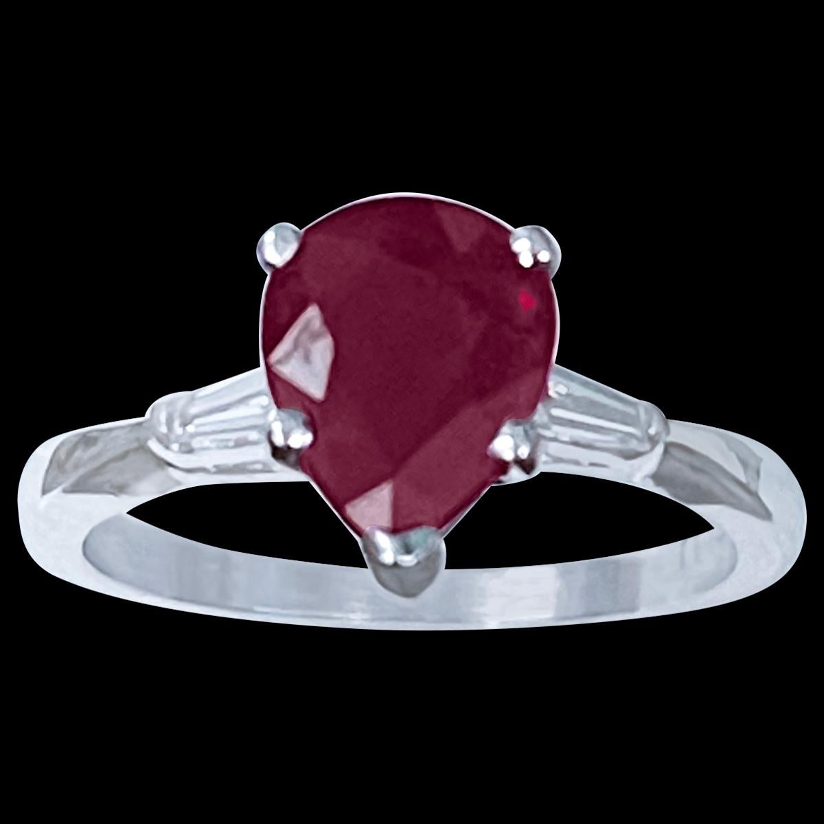 Pear Shape 2 Carat Treated Ruby & Diamond 14 Karat White  Gold Ring Size 6.5
Its a treated ruby
 prong set
14 Karat White  Gold: 3.5 gram
Measurement 9X7
two diamond baguettes , one on each side of the ruby 
Ring Size 6.5 ( can be altered for no