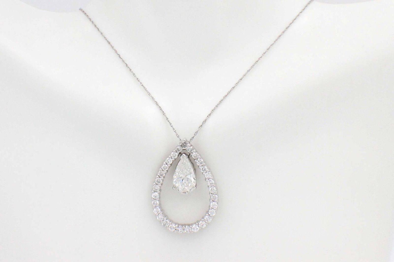 PEAR SHAPE DIAMOND & ROUND DIAMONDS PENDANT NECKLACE
Metal:  14KT White Gold
Size:  1.25 X 0.75 Inches
Length:  16 Inches
Total Carat Weight:  3.88 TCW
Diamond Shape:  Pear Shape 2.43 CTS
Diamond Color & Clarity:  H / I1
Accent Diamonds:  29 Round
