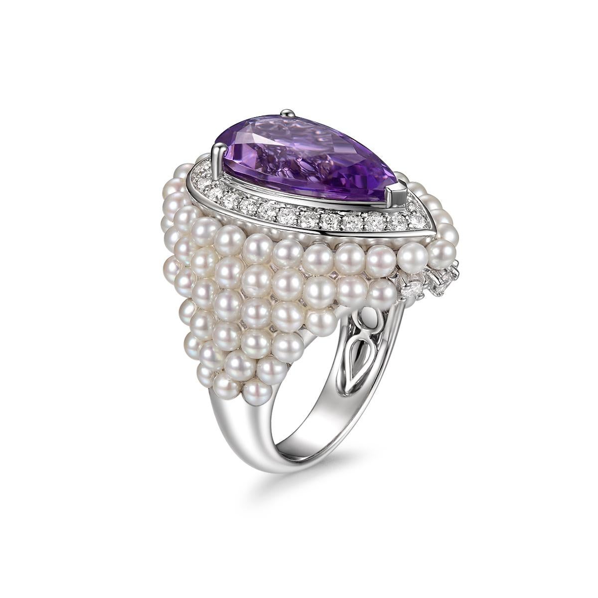 A White Gold, Amethyst and Freshwater Pearl Ring created by Sisi.
14 karat white gold centering one pear-cut amethyst weight 5.66 carat ,within a bubbling mount of freshwater pearls, accented with 0.61 carat of white round brilliance diamond. 