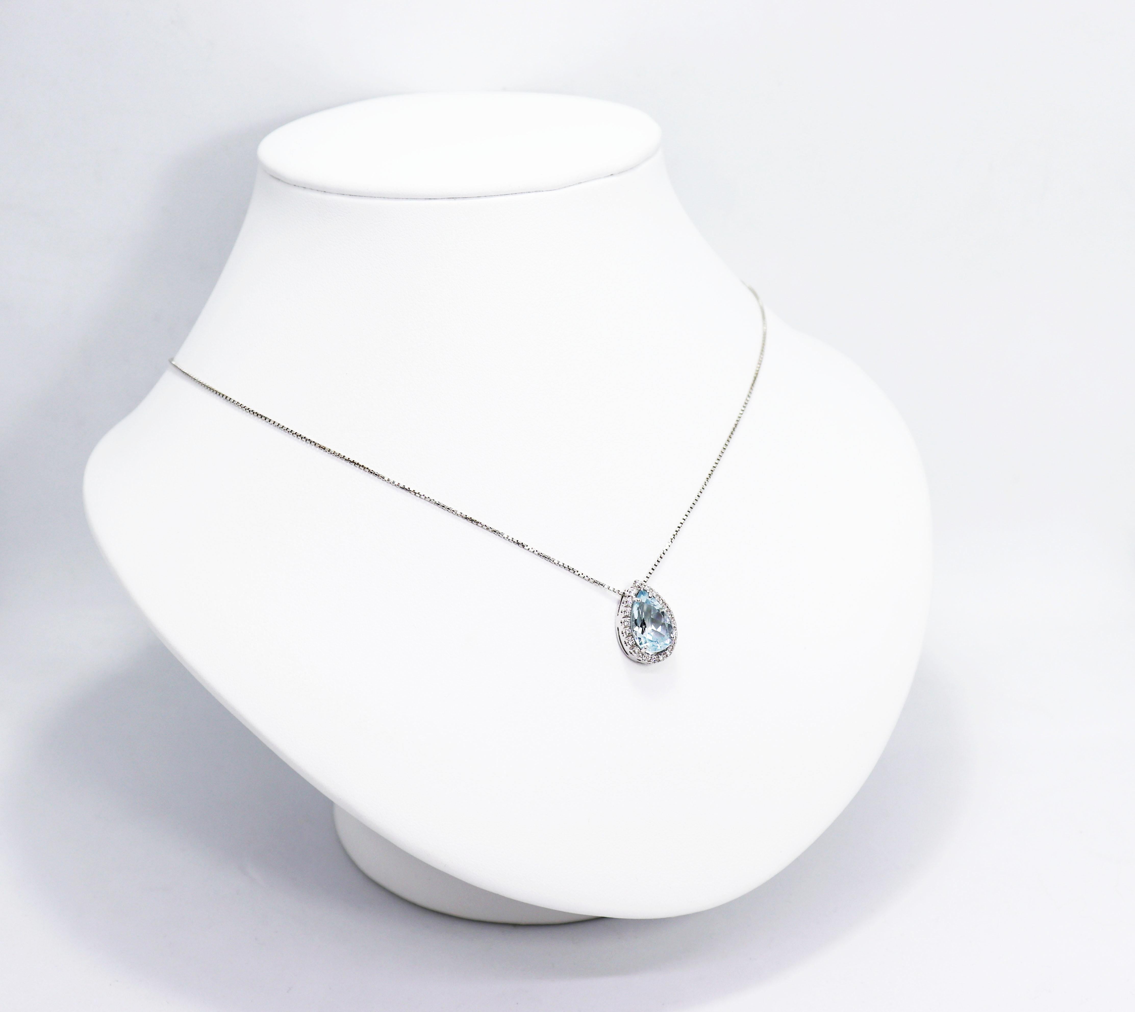 Italian pendant featuring a beautiful pear shape aquamarine weighing approximately 2.50ct in a four claw setting, surrounded by 20 round brilliant cut diamonds weighing approximately 0.20ct total, all in 18 carat white gold, open back claw settings.