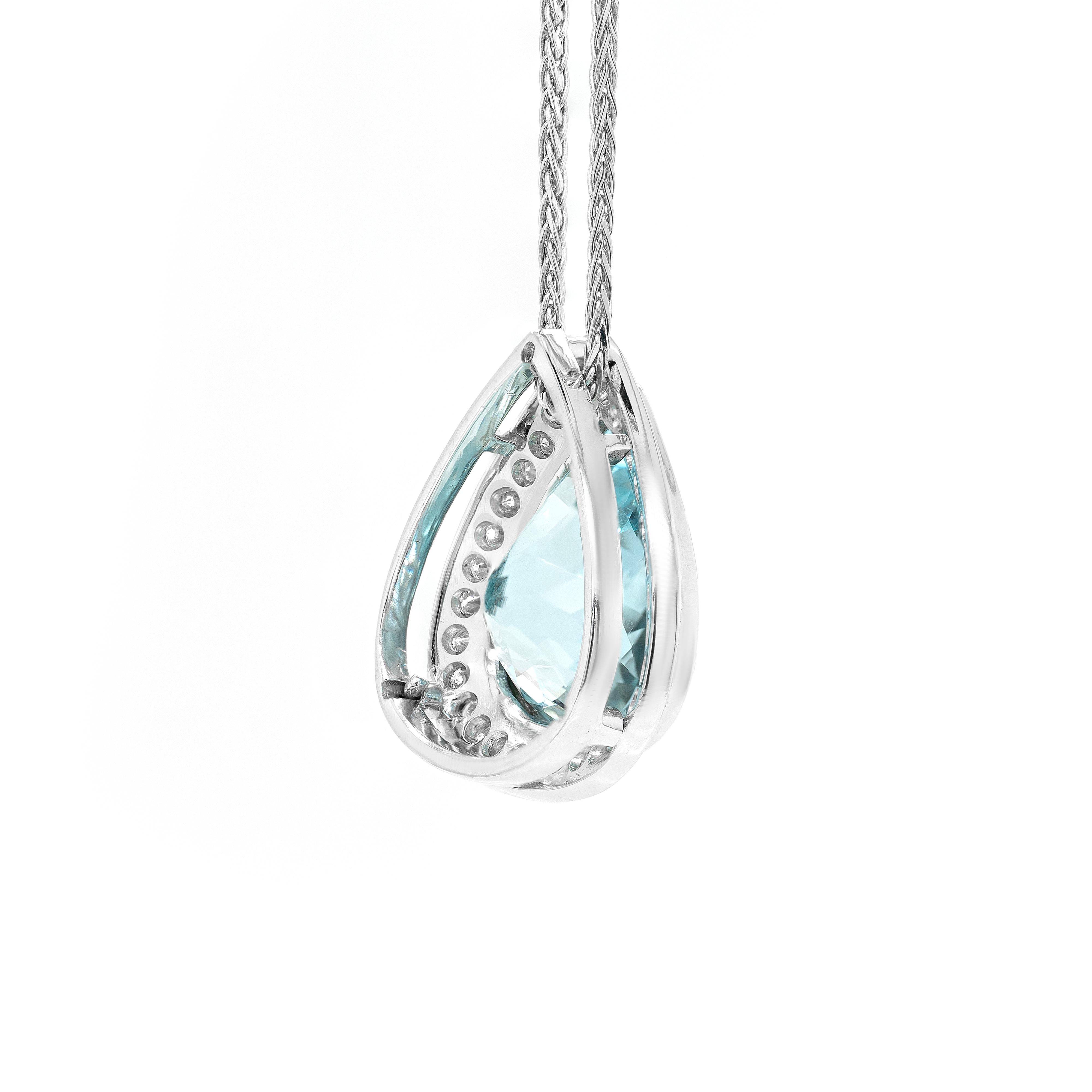 This gorgeous pendant features a wonderful pear shaped aquamarine weighing approximately 11.00ct, mounted in a rub-over, open back setting. The translucent gemstone is beautifully surrounded by a halo of 30 round brilliant cut diamonds weighing a
