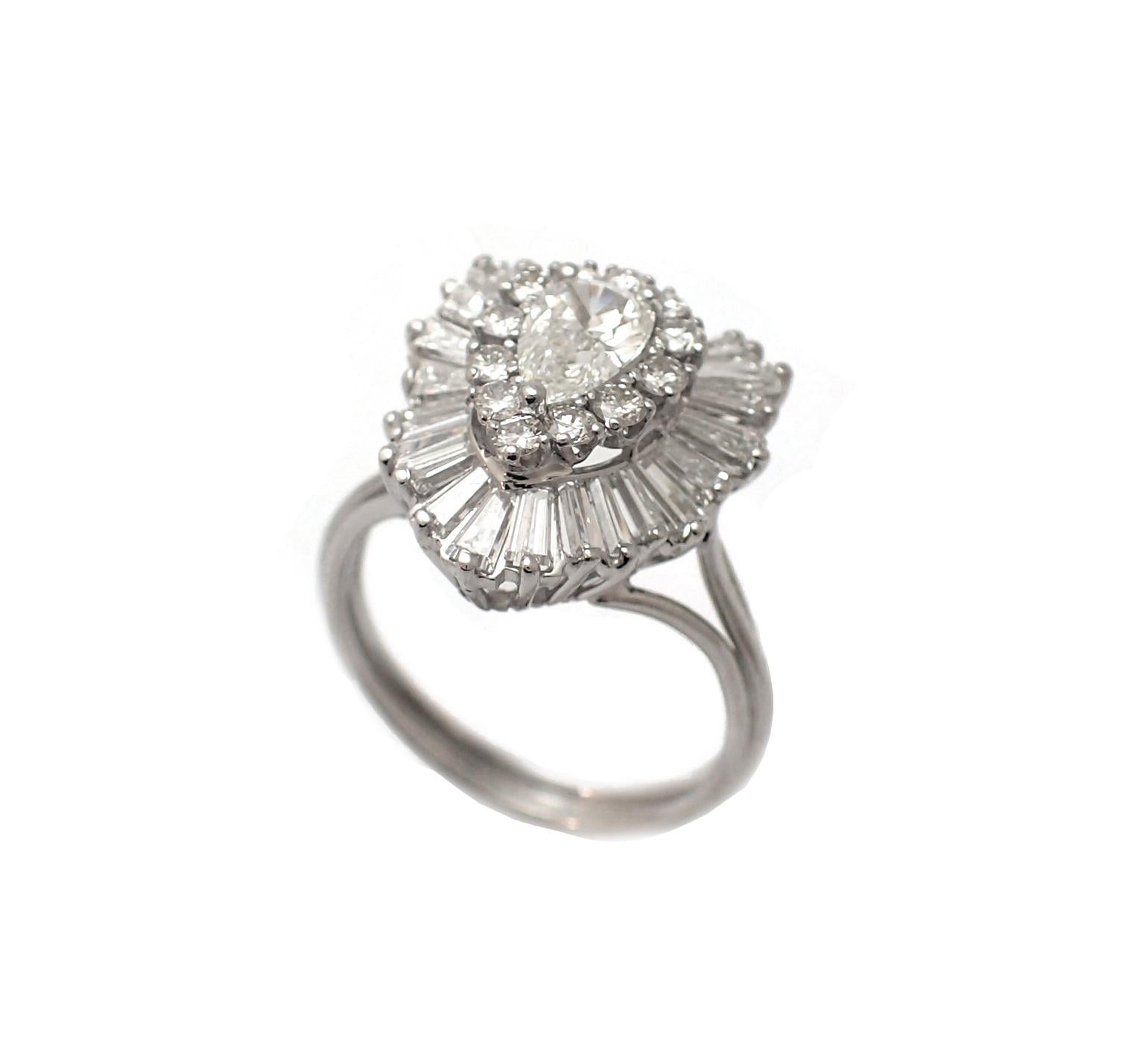 This magnificent example of 1960s ballerina style rings features a 0.6ct (estimated) center stone surrounded by a 