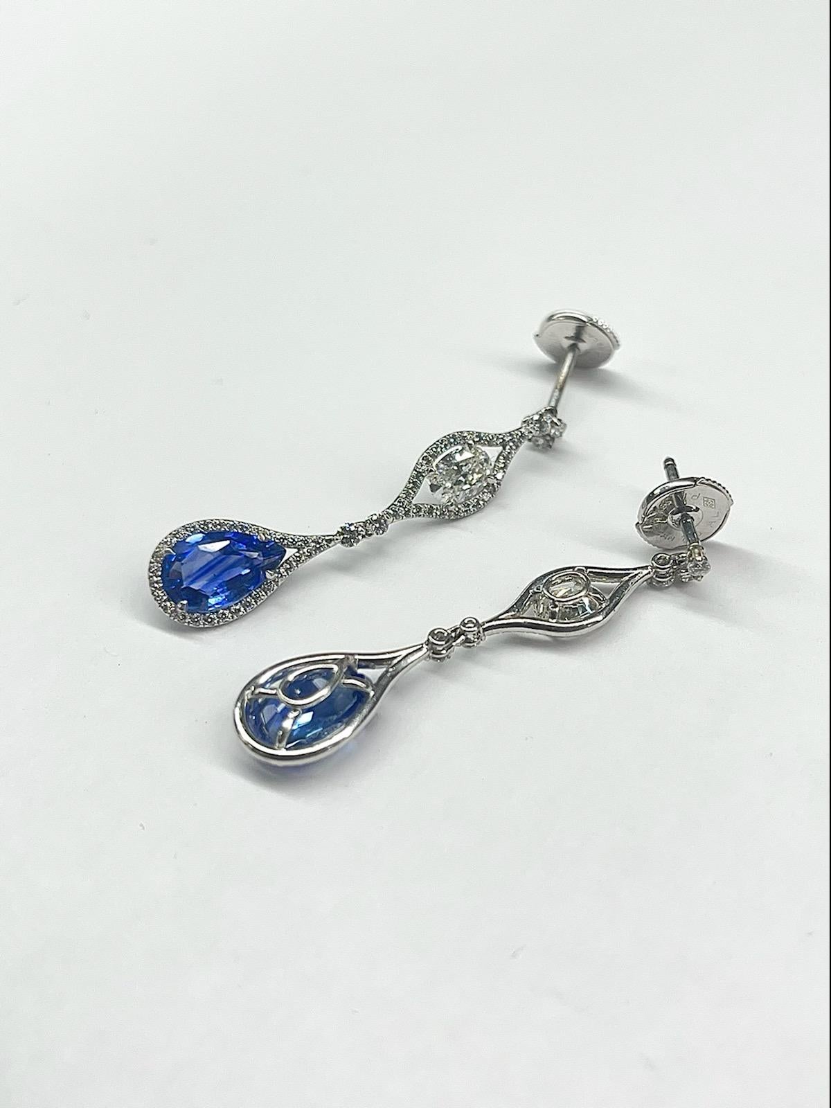 You can't go wrong these beautiful pear shaped blue sapphire earrings! 
Wear them out for a special occasion or give them as an amazing gift! 
Two (2) Pear Shape Blue Sapphires weigh  3.84cts Total 
2.19 Carats of Round Brilliant Cut Diamonds - All