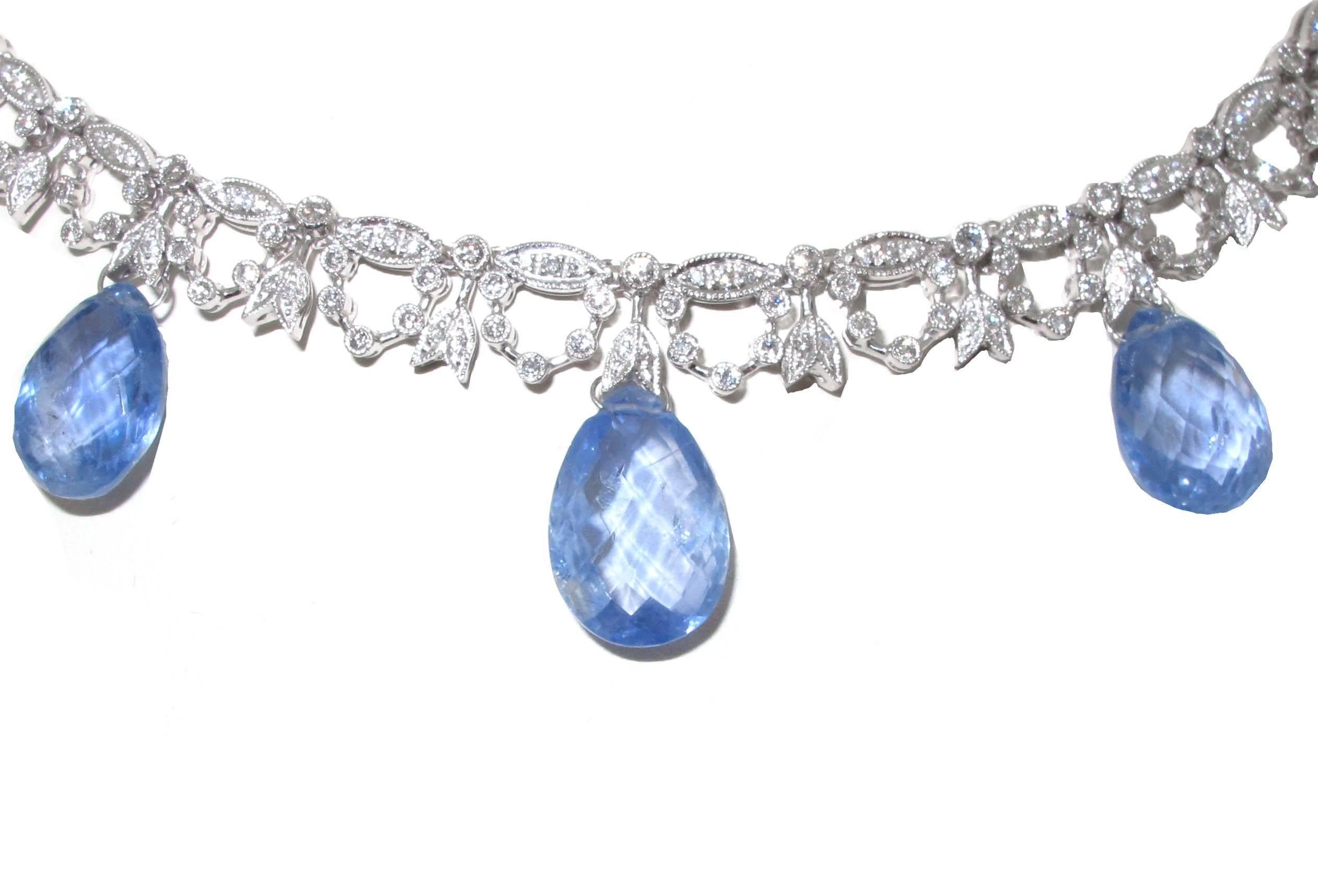Such a fantastically delicate platinum set Briloette cut pear shape sapphire necklace. On the base of the necklace is white diamonds of great quality. The necklace will fit a standard neck. Our favorite part of this necklace is how the light bounces
