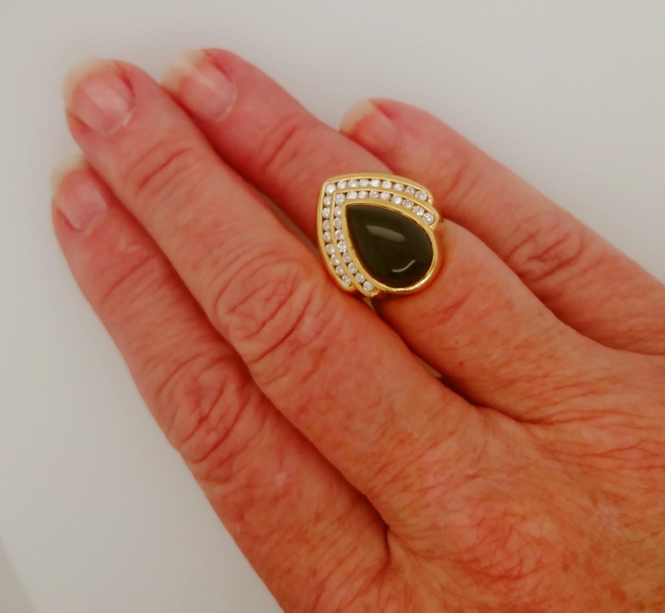 Pear Shape Cabochon Cut Onyx and Diamond Ladies Fashion Statement Ring features 18K stamped inside of Yellow Gold  shank in addition to the copyright stamp.  The black onyx center is 14.5x10mm with overall ring top a stunning 21.5x19.5mm overall.