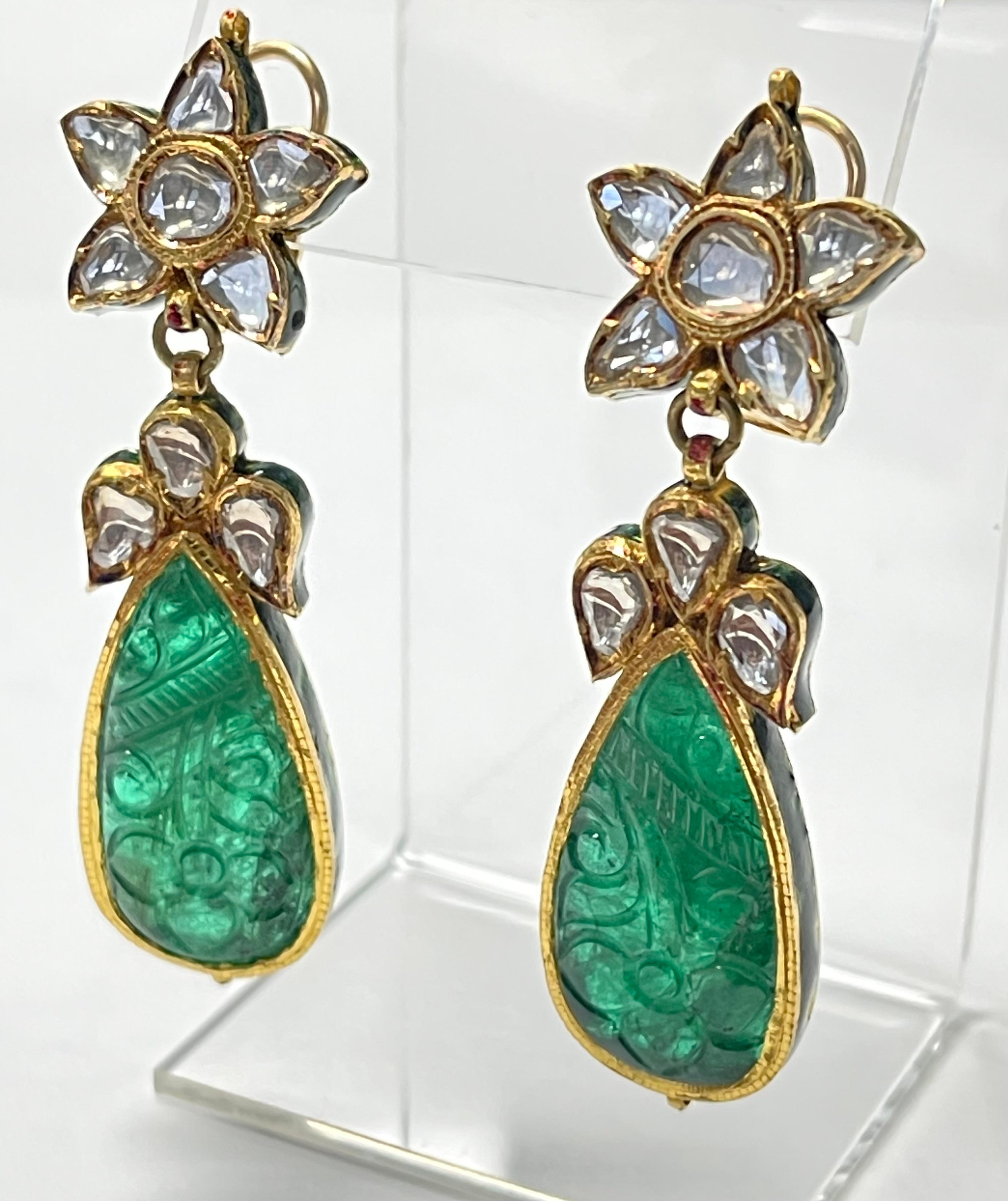 These gorgeous and one a kind carved and diamond earrings are beautifully handmade in yellow gold . 

The details are as follows : 

Pear shape emerald weight : 40 carats approximately 
Diamond weight : 2.50 carats 
Gold : Yellow gold 
Gross Weight