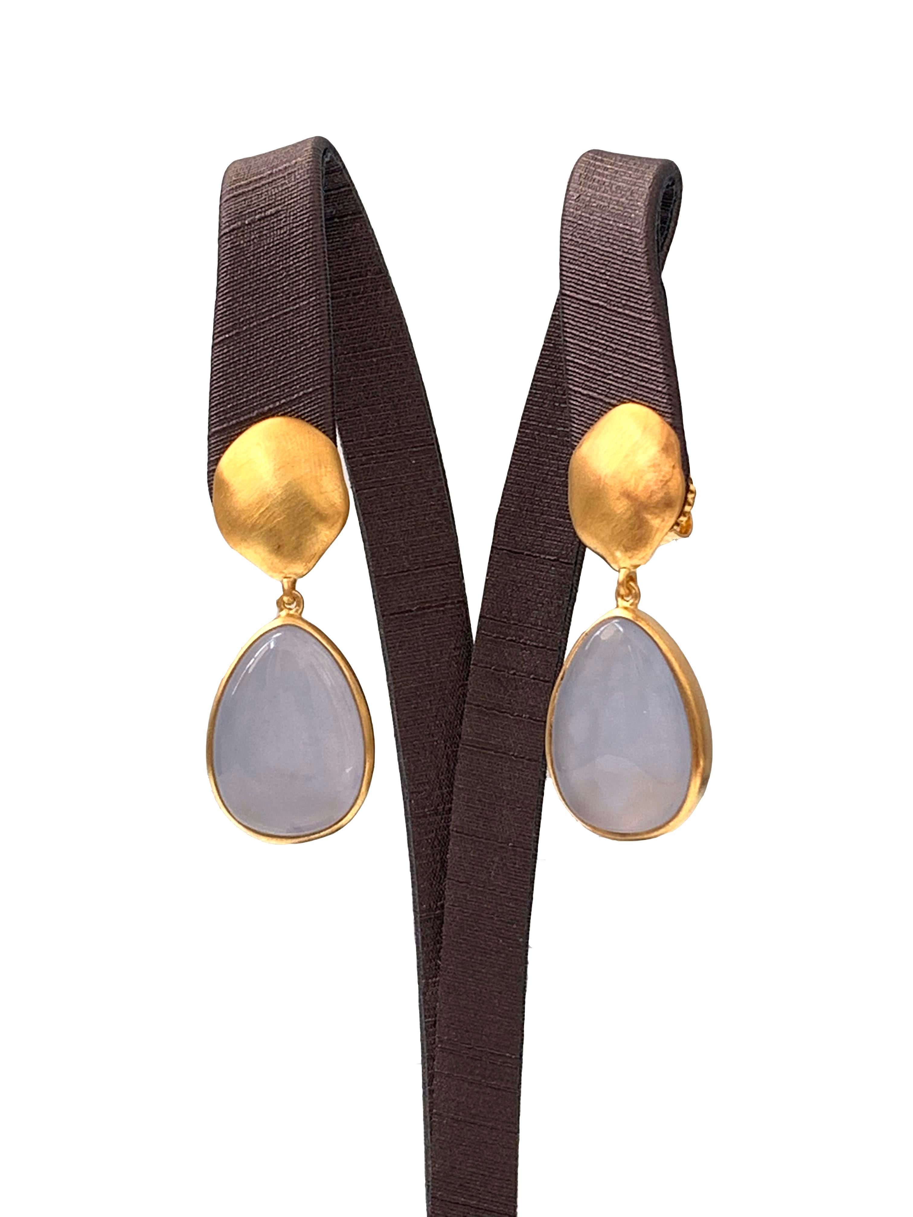 Discover pear-shape Chalcedony vermeil drop earrings. The earrings feature 2 large pear-shape cabochon-cut Chalcedony with unique periwinkle purple-ish blue hue, handcrafted brushed satin texturing technique, and hand set in vermeil 18k gold plated