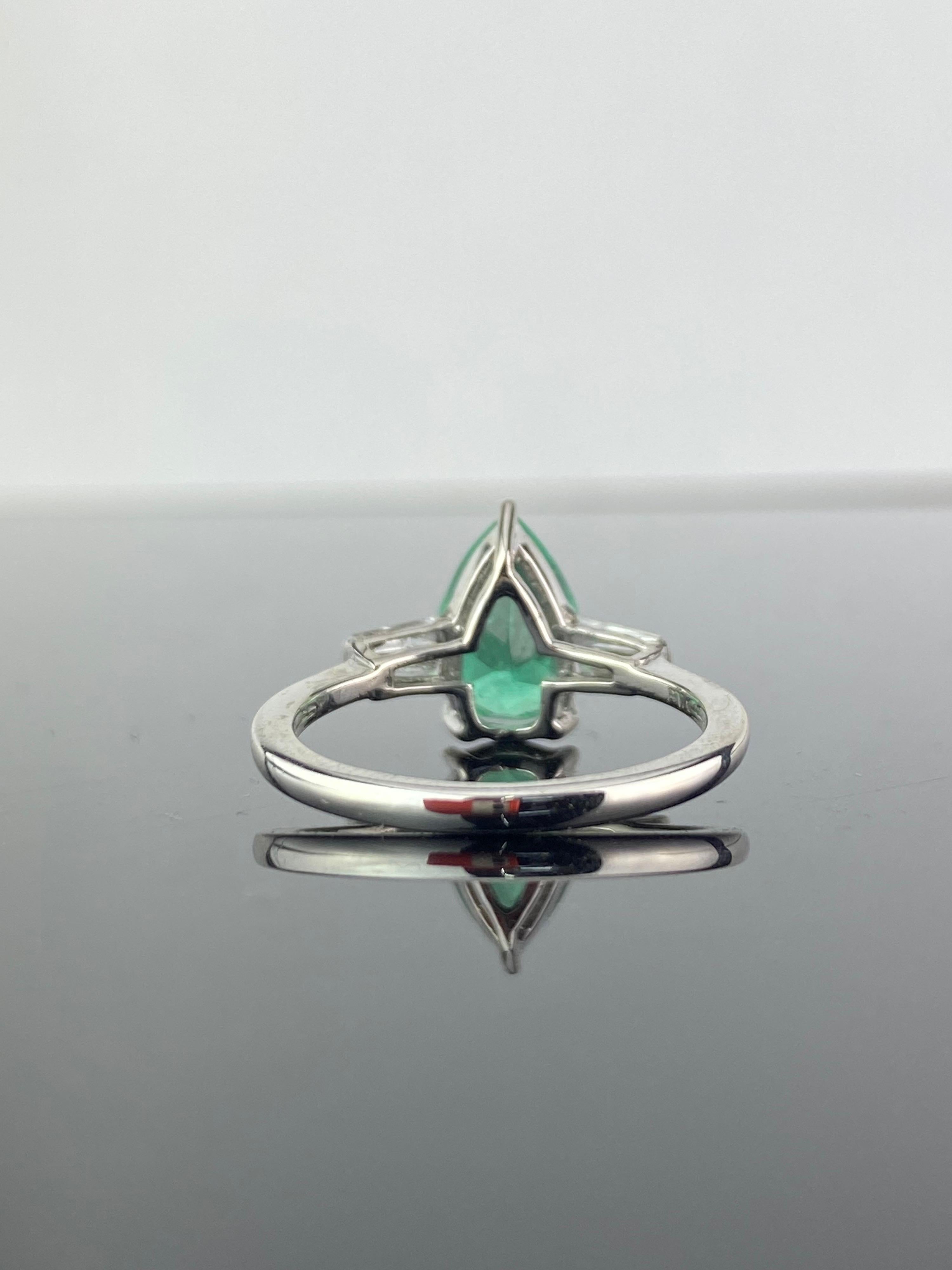 A beautiful, versatile, 0.83 carat natural Colombian Emerald and 0.2 carat Diamond baguette three-stone engagement ring, set in Platinum. Currently sized at US 6, can be resized. 