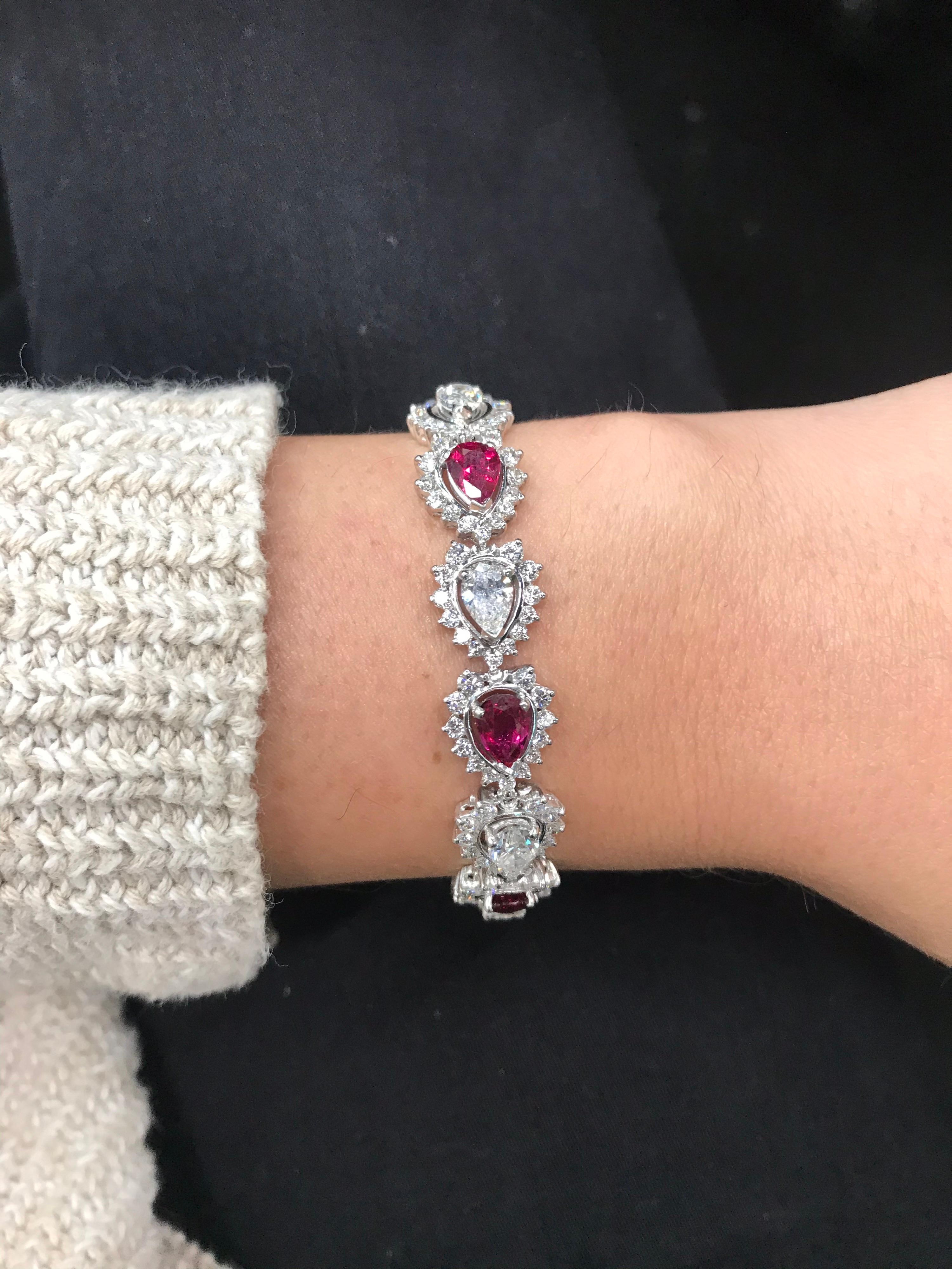 This bracelet features seven alternating pear shape diamond and rubies and each one is flanked with a diamond halo, crafted in platinum.
Rubies: Approximately 6 Carats
Diamonds: Approximately 11.50 Carats

Color: G-H
Clarity: SI
