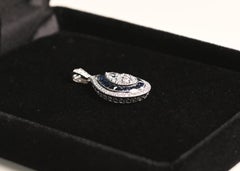 Pear Shape Diamond and Sapphire Pendant. 18 Karat White Gold Double Halo Bezel