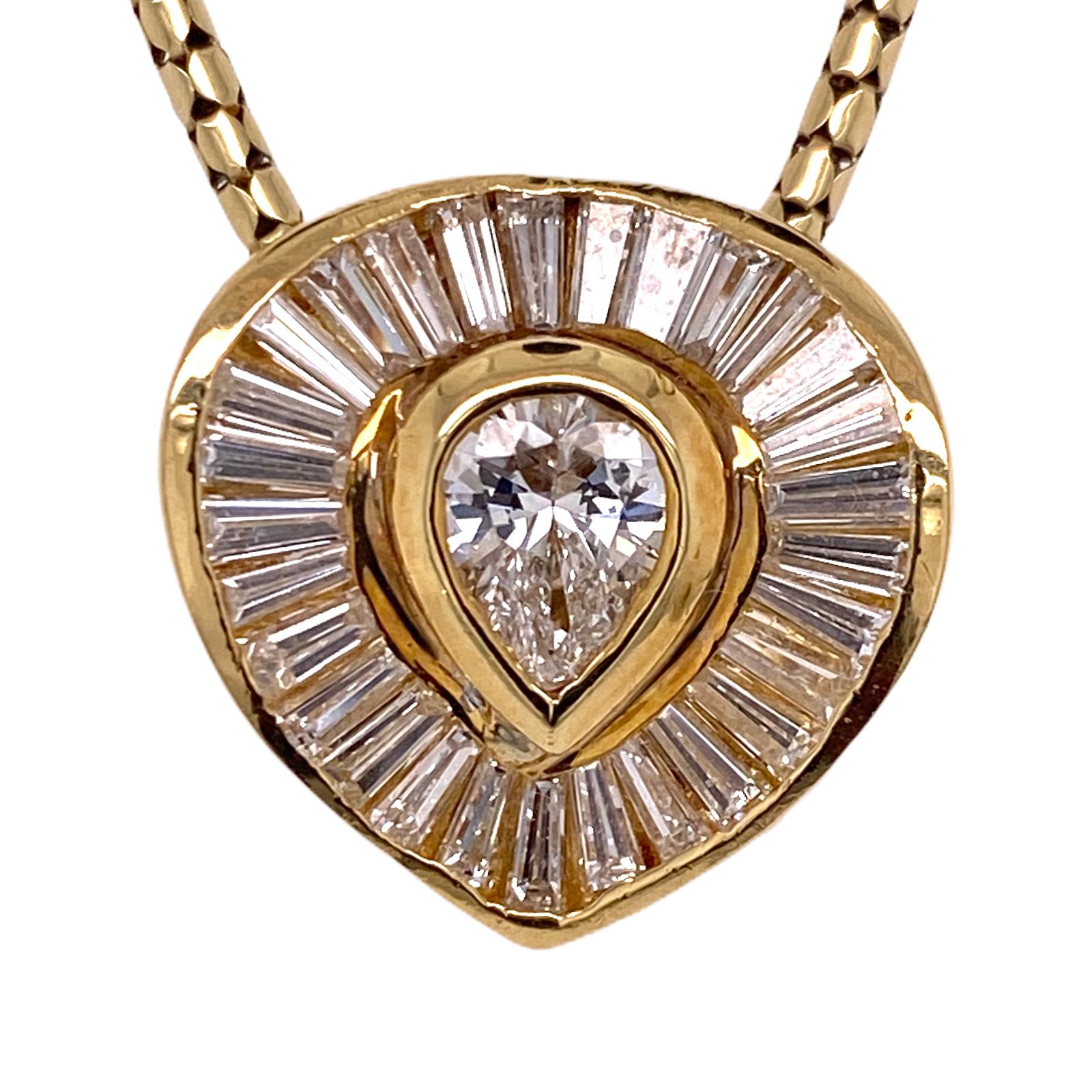Beautiful diamond pendant fashioned in 14 karat yellow gold. The pendant features a center pear cut diamond weighing .65 carats, the diamond is surrounded by baguette cut diamonds weighing approximately 1.12 carat total weight (1.77 CTW). The