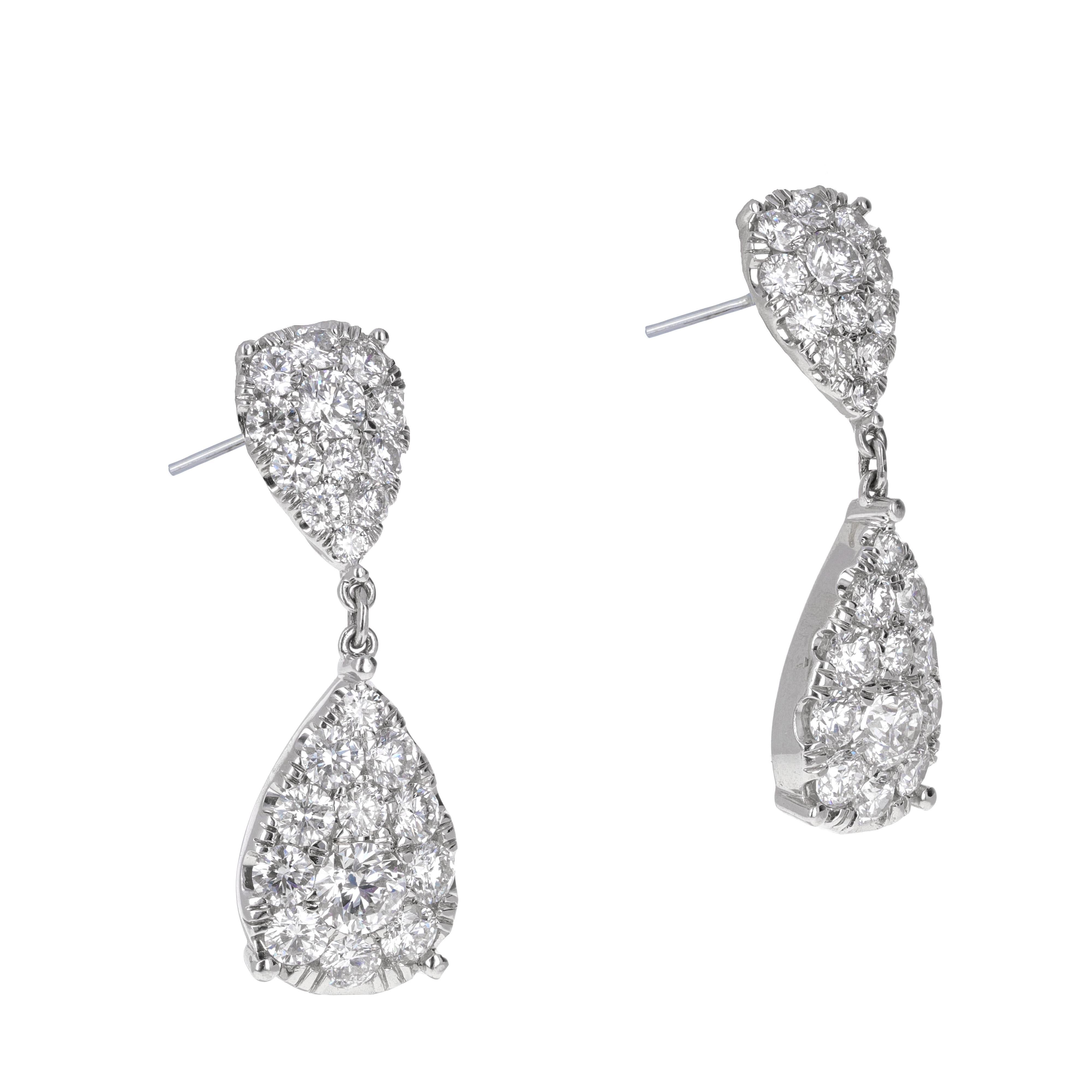 18 karat white gold diamond pear shape dangling earrings. The earrings are made up of smaller round diamonds and give the illusion of a larger stone.
There is a total of 5.98 carats in the earrings.