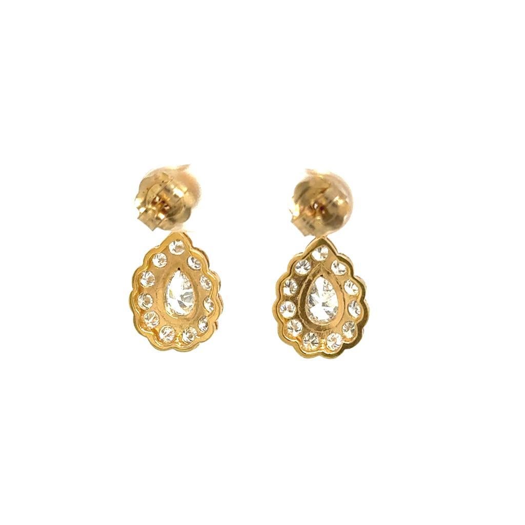 18ct Yellow Gold Classic, elegant and timeless, these drop earrings feature a pear shape diamond that is set with round brilliant diamonds in beautiful design. The diamonds are set in 18ct Yellow Gold. Not Hallmarked, but tested as 18ct Yellow