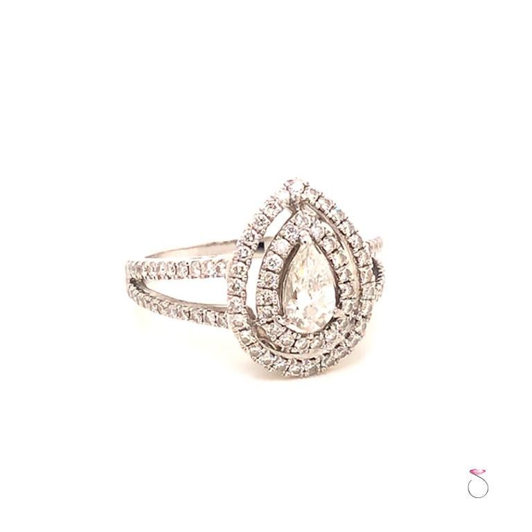 Pear Shape Diamond Engagement Double Halo Ring in18k White Gold. The center pear shape diamond is ~0.38 carats, G in color and VS1 in clarity. The diamond is set in 3 prongs and surrounded by a double halo set with 48 round brilliant cut diamonds