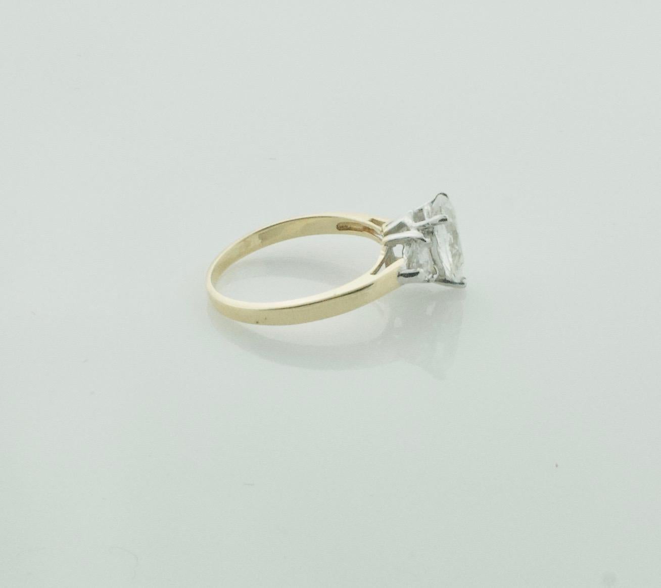 Pear Shape Diamond Engagement Ring 1.23 Carats GIA GVS2 in 18k Gold
A Lovely Two Tone Design
One Pear Shape Diamond Weighing 1.23 its. GIA Certified G VS2
Two Trilliant Cut Diamonds Weighing .60 carats approximately   [G VS]