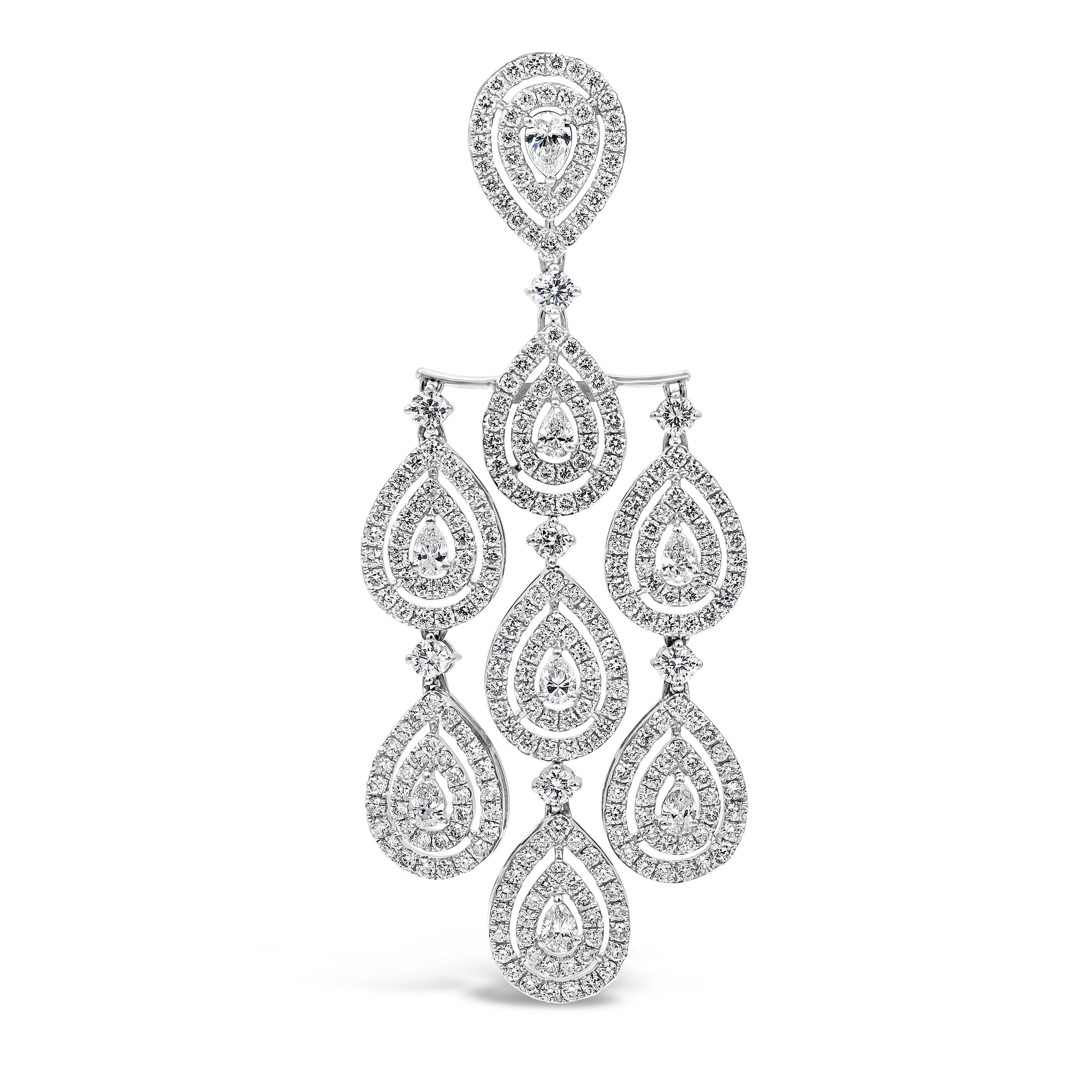 A brilliant pair of earrings showcasing pear shape diamonds, surrounded by two row of double halo round brilliant diamonds weighing 9.25 carats total. Set in a chandelier design and Finely made in 18k white gold.

Style available in different price