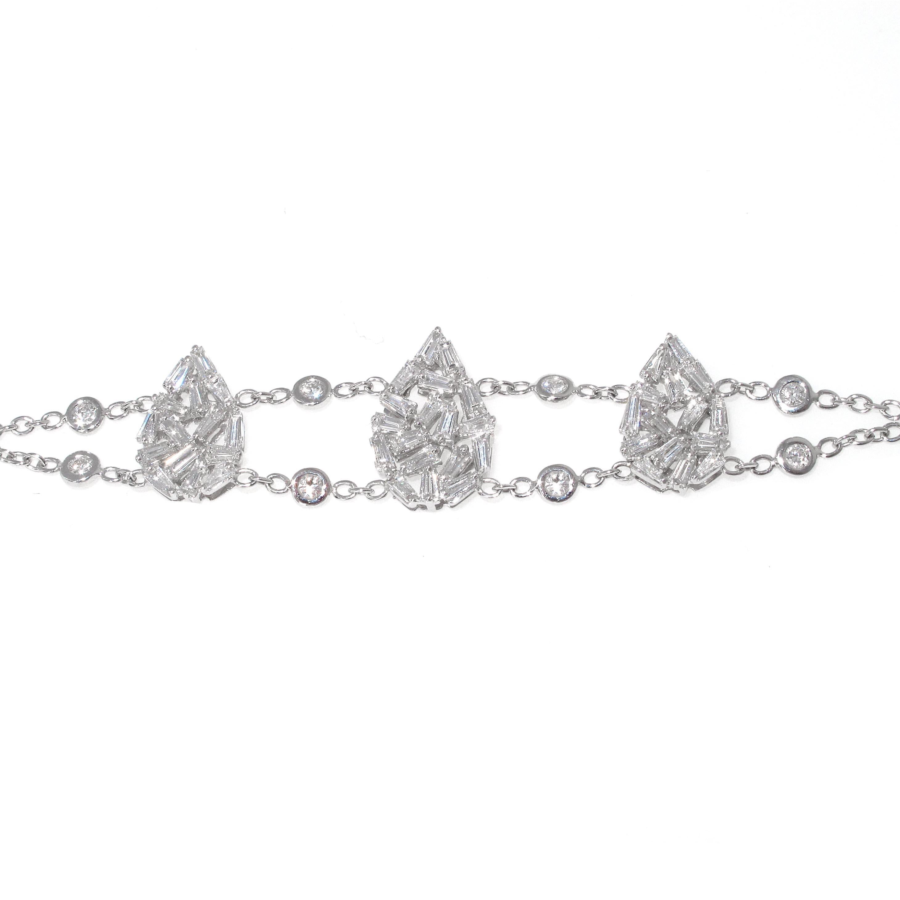 What a great looking, easy to wear diamond bracelet. The baguettes in the center are done in a mosaic fashion to look like 3 larger pear shapes. The bracelet is made in 18k white gold which is much higher quality than 14kt white gold. This is a