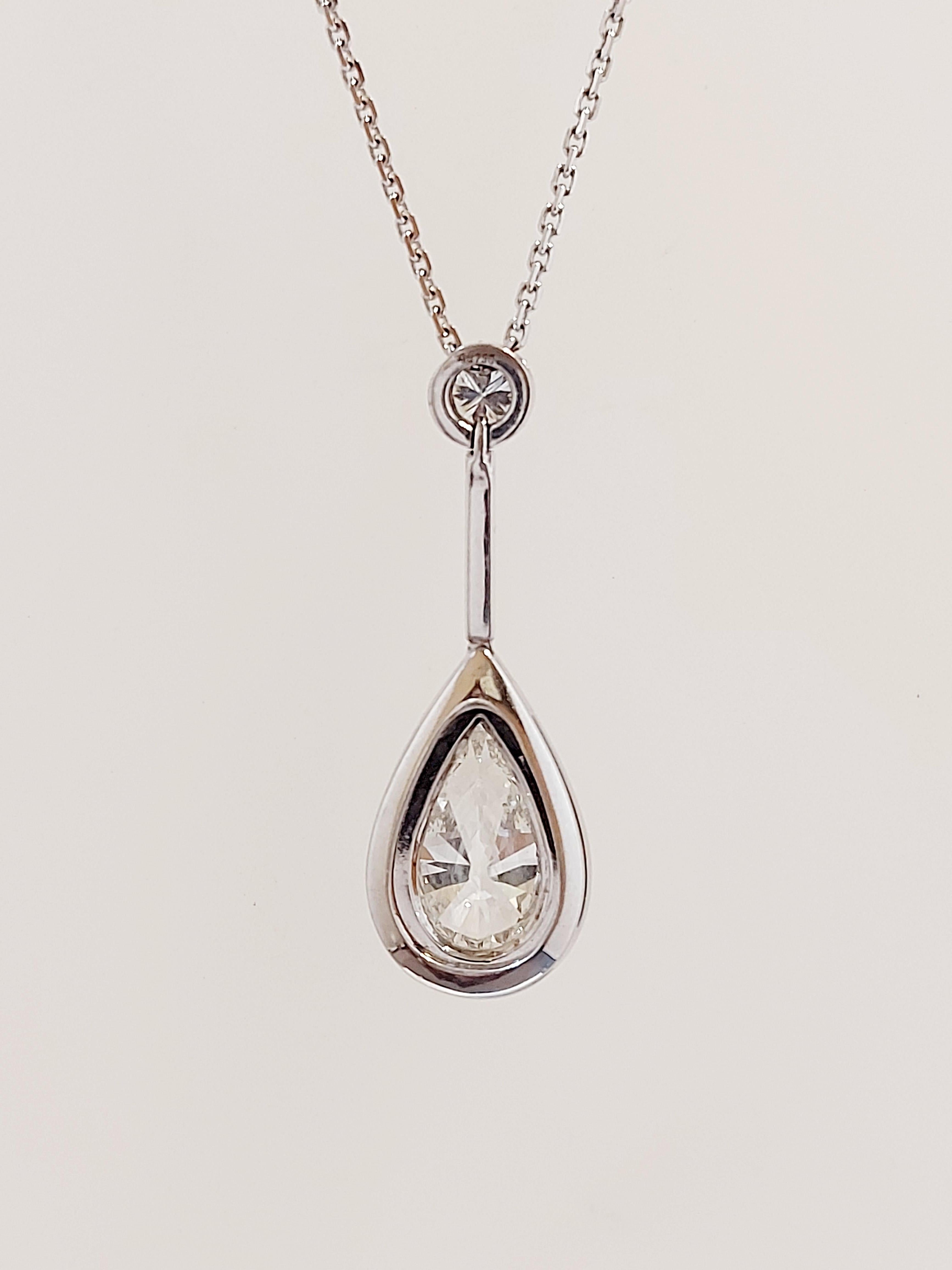 An impressive pear shape diamond drop pendant in a rub over setting, a 3.18ct pear shape diamond colour H, clarity SI2, in the centre of .35ct diamond grain set halo suspended from a bar with a rub over set diamond .51ct, colour G, clarity SI1 total
