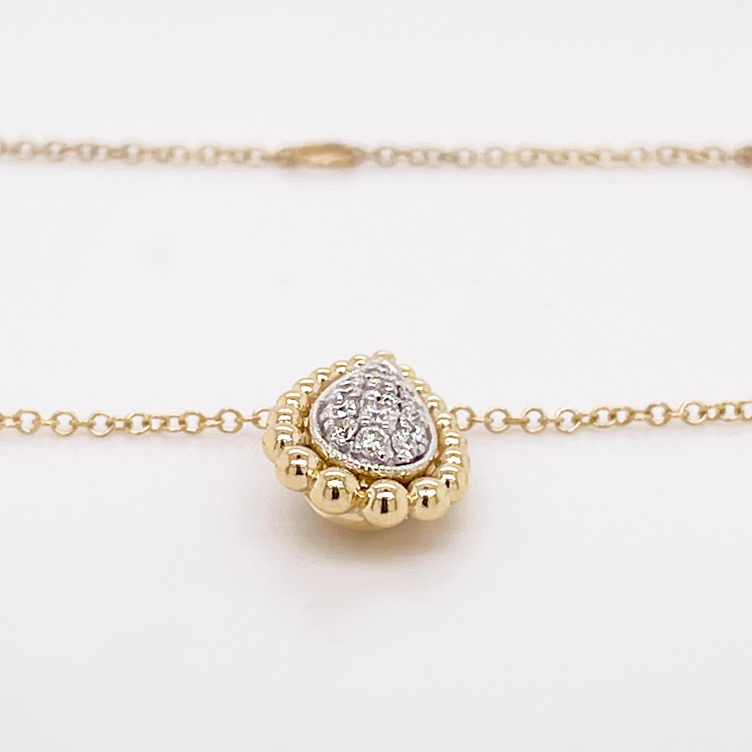 This beautiful pear shaped diamond necklace has pave set diamonds. The entire pear shape is set in 14 karat white gold and the beaded frame and chain is solid 14 karat yellow gold.  This is a mixed metal design that is desired by many. This is the