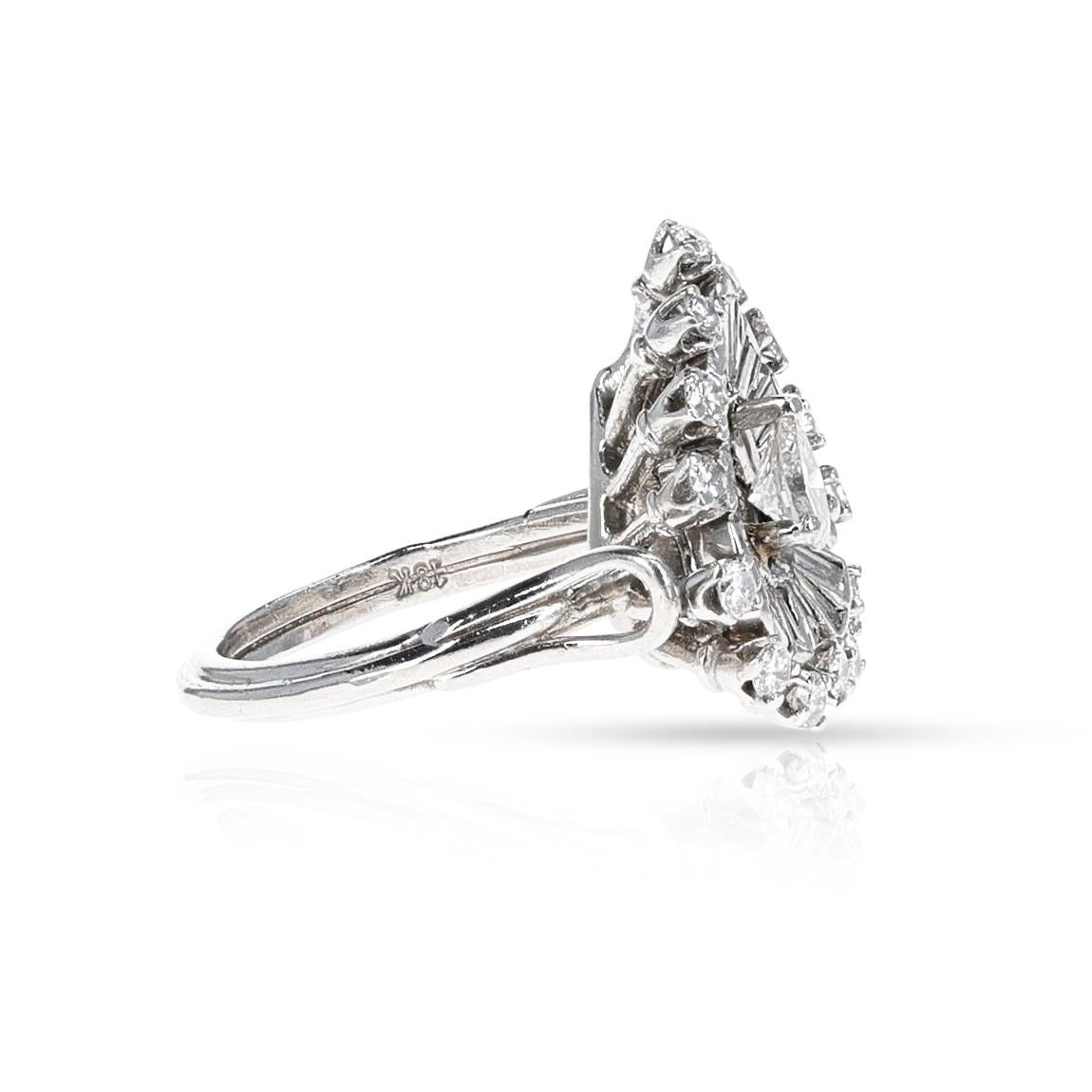 A Pear Shape Diamond Ring with Baguette and Round Diamonds made in Platinum. The total weight of the ring is 9.37 grams. The ring size is US 5.25. 