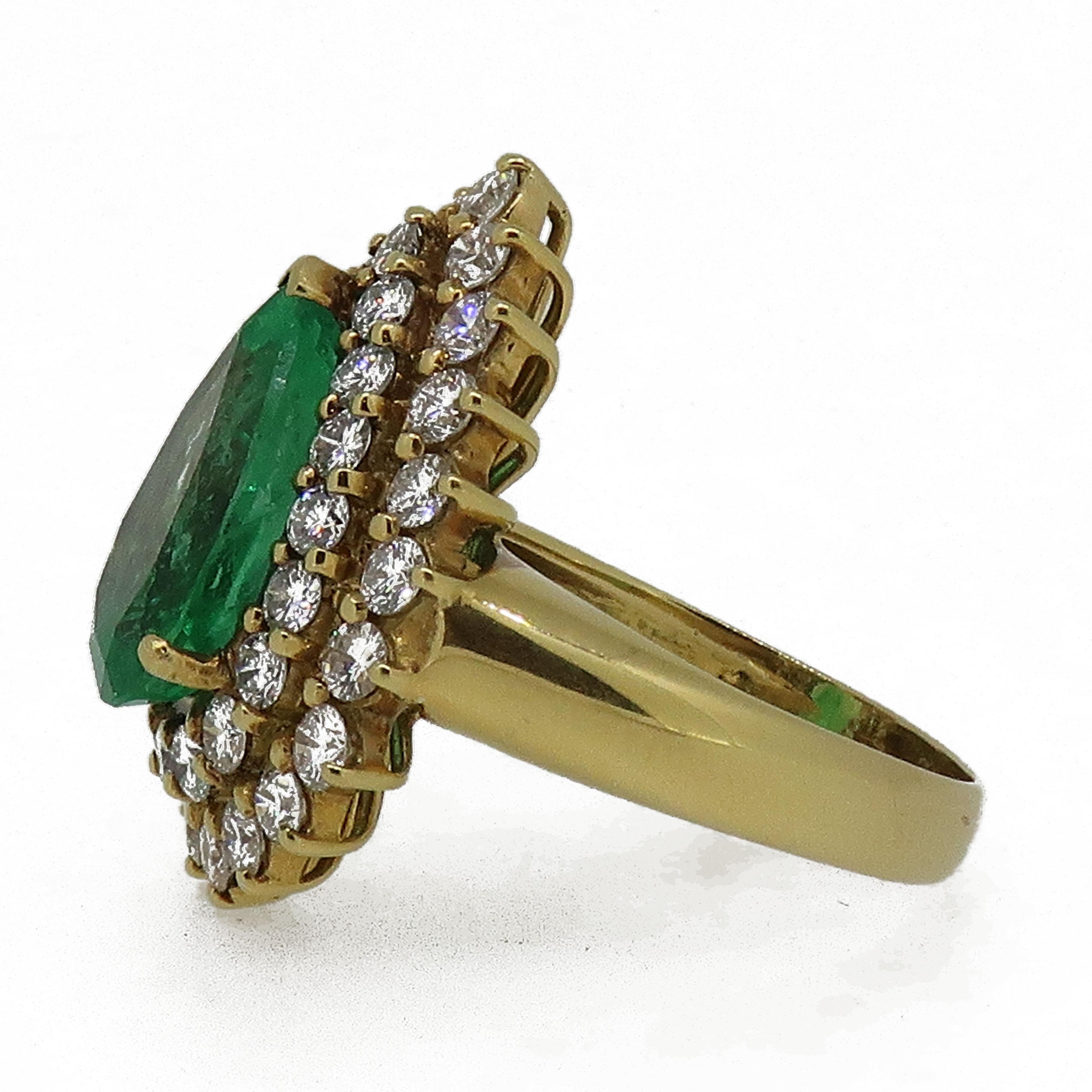 Pear Shape Emerald & Diamond Cluster Ring Yellow Gold

A truly mesmerising pear shape Columbian emerald, surrounded by two rows of  white brilliant cut diamonds all in a claw setting. 
The pear shape emerald measures a whopping 14.2 x 9.6mm, the