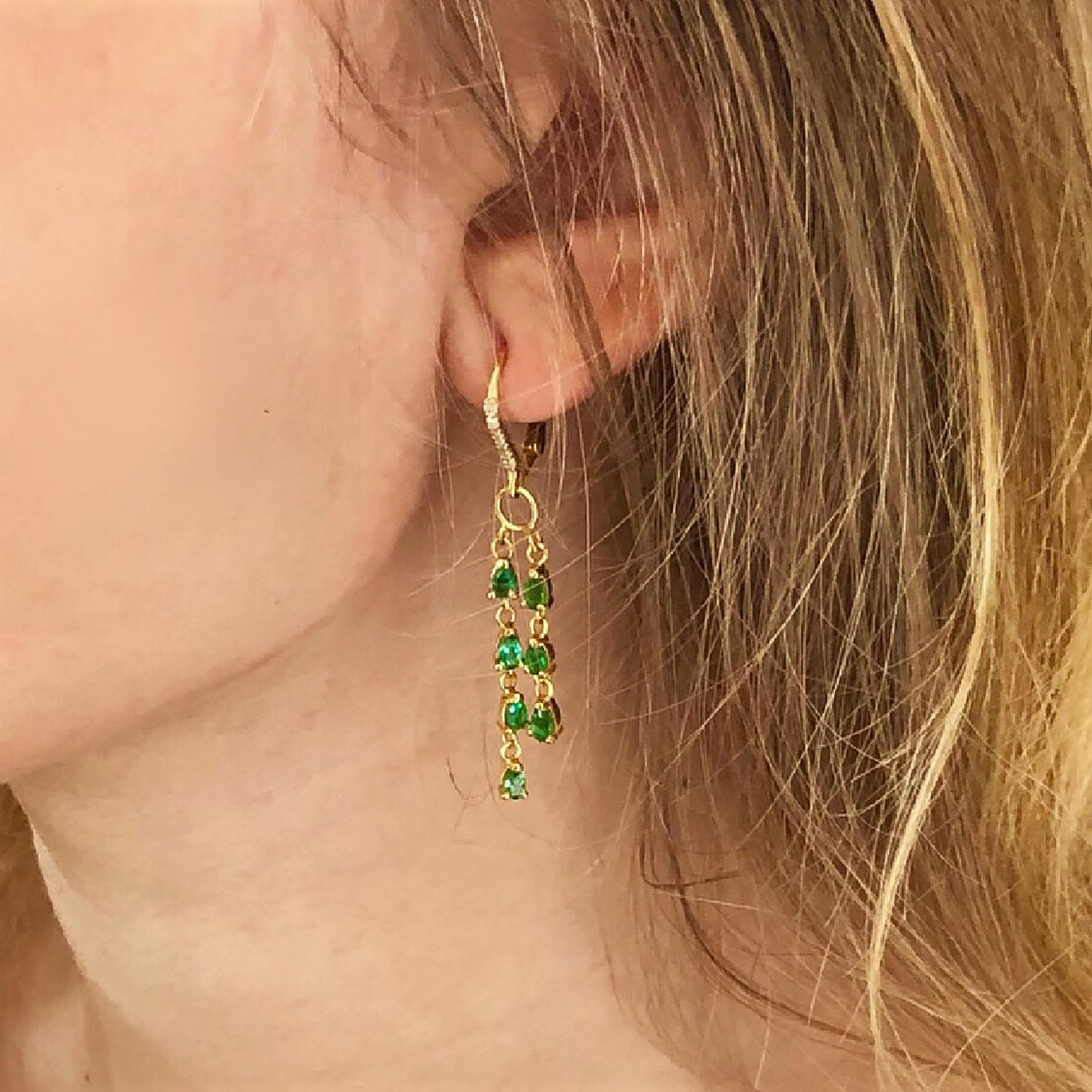 Fourteen karats yellow gold diamond and emerald hoop drop earrings 
Earrings are 1.75 inches long
Fourteen pear Shape emerald weighing 3.50 carat
Diamond weighing 0.25 carat 
Emerald quality bright and vivid green
New Earrings
Handmade in the