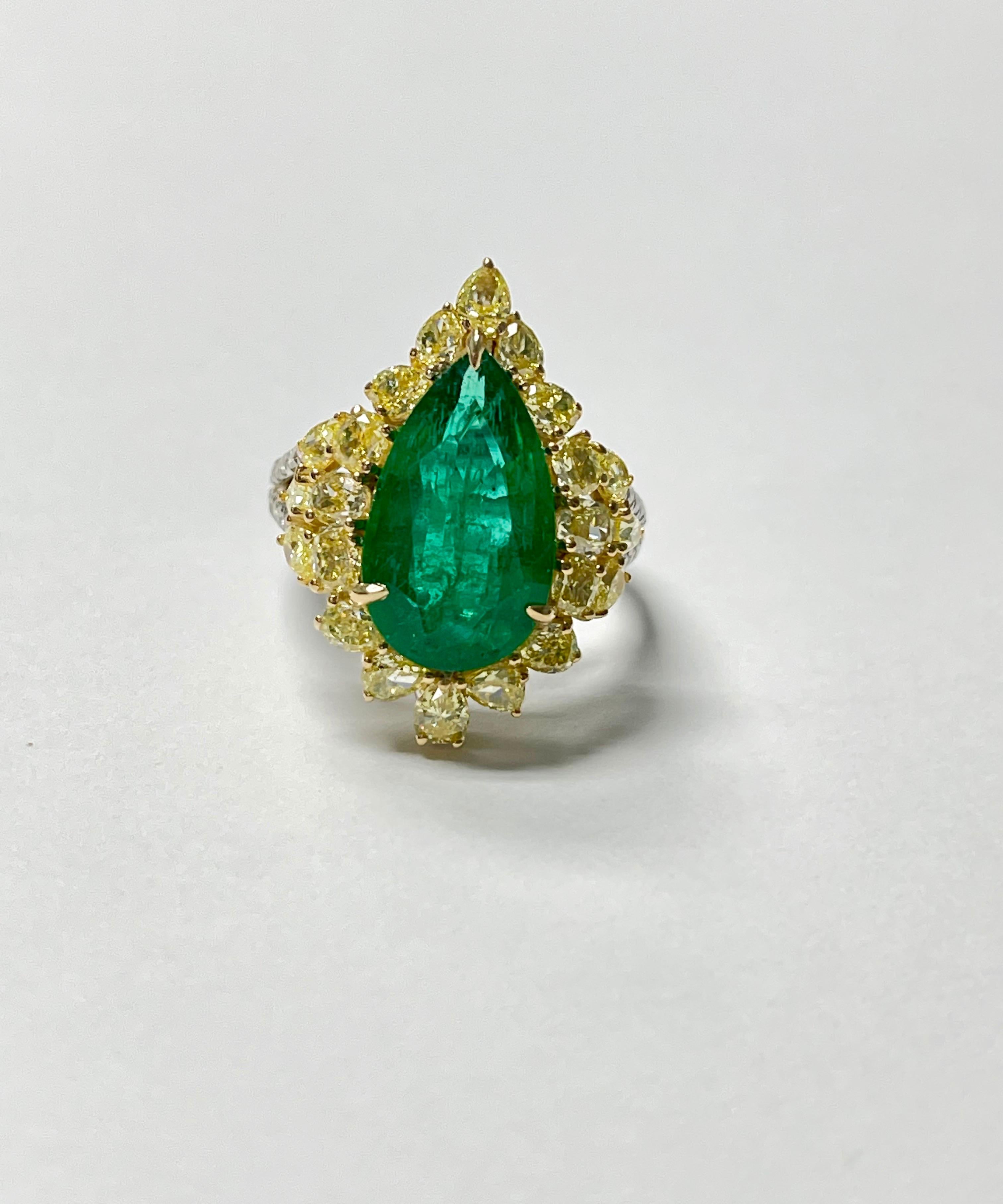 Gorgeous Pear Shape Emerald and yellow diamond engagement ring beautifully handmade in 18k yellow and white gold. 
The details are as follows : 
Pear shape emerald weight : 2.37 carat 
Fancy yellow diamond weight : 3.08 carat 
Metal : 18 k yellow